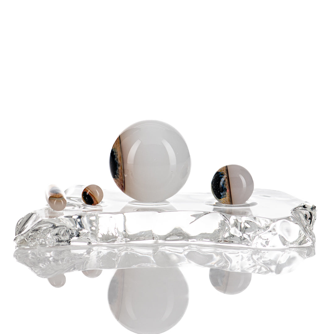 Deluxe Indo Glass Eye Slurper Set featuring clear glass tools with intricate designs for dabbing and concentrate use.