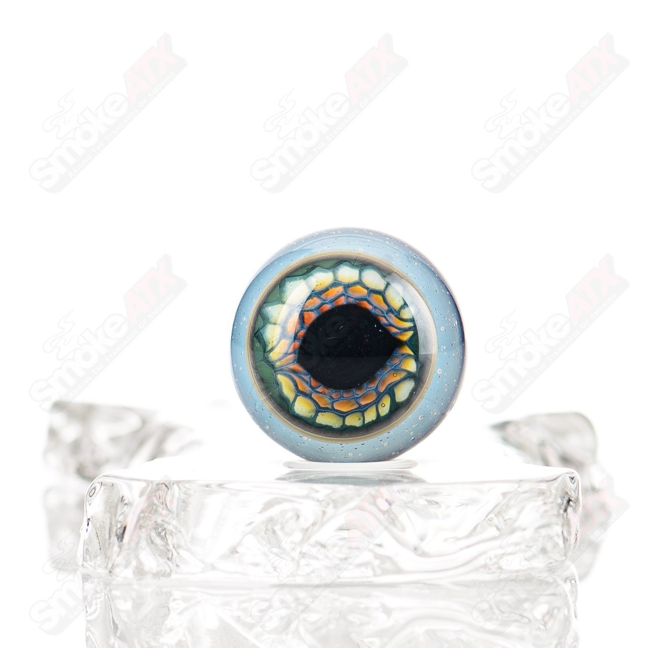 Silver Creek Eye Marble from Indo Glass, clear glass marble with eye-like swirl patterns, suitable for decorative or collection purposes