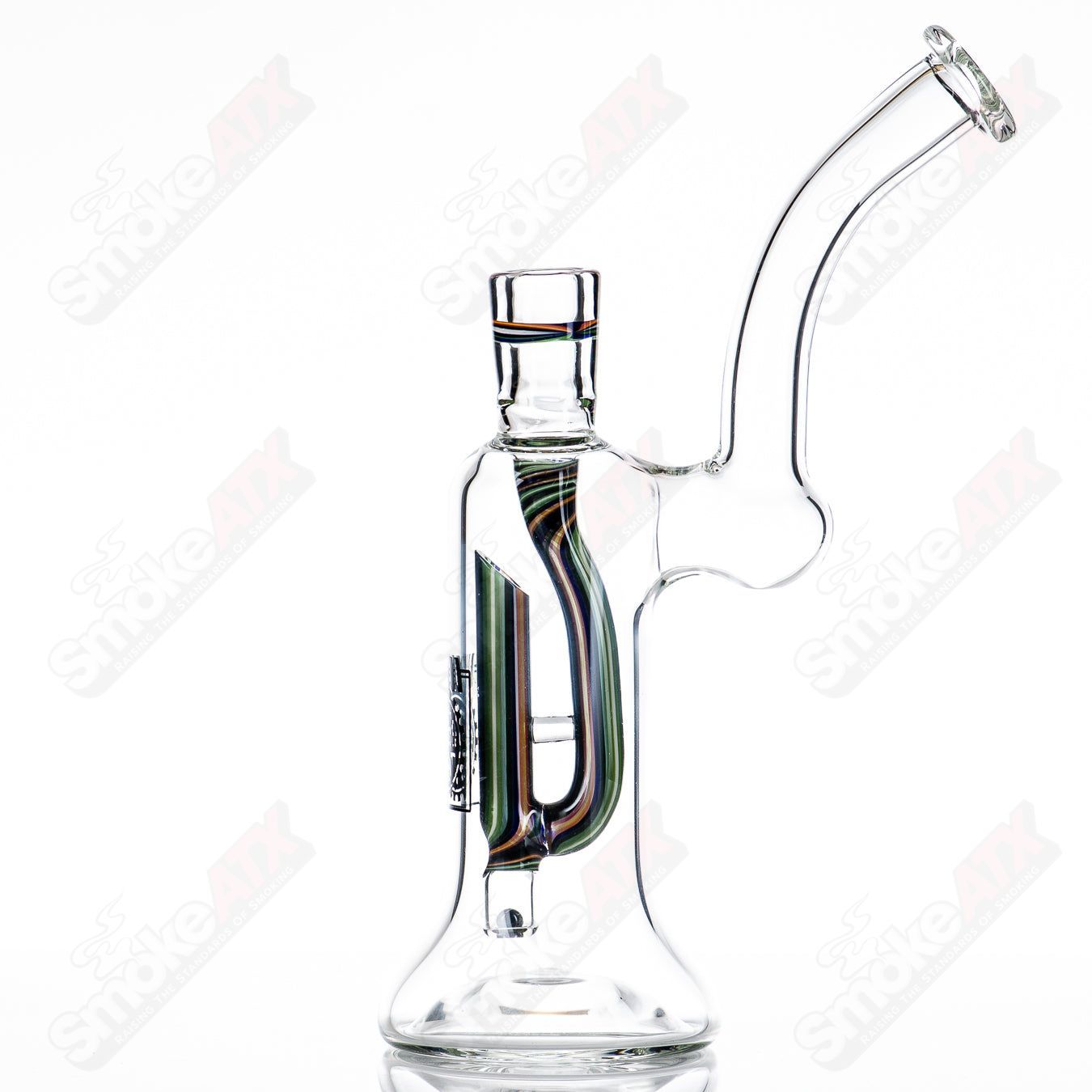 Steve Bates x WORM glass diffusion pump concentrate rig with intricate design and clear glass construction.