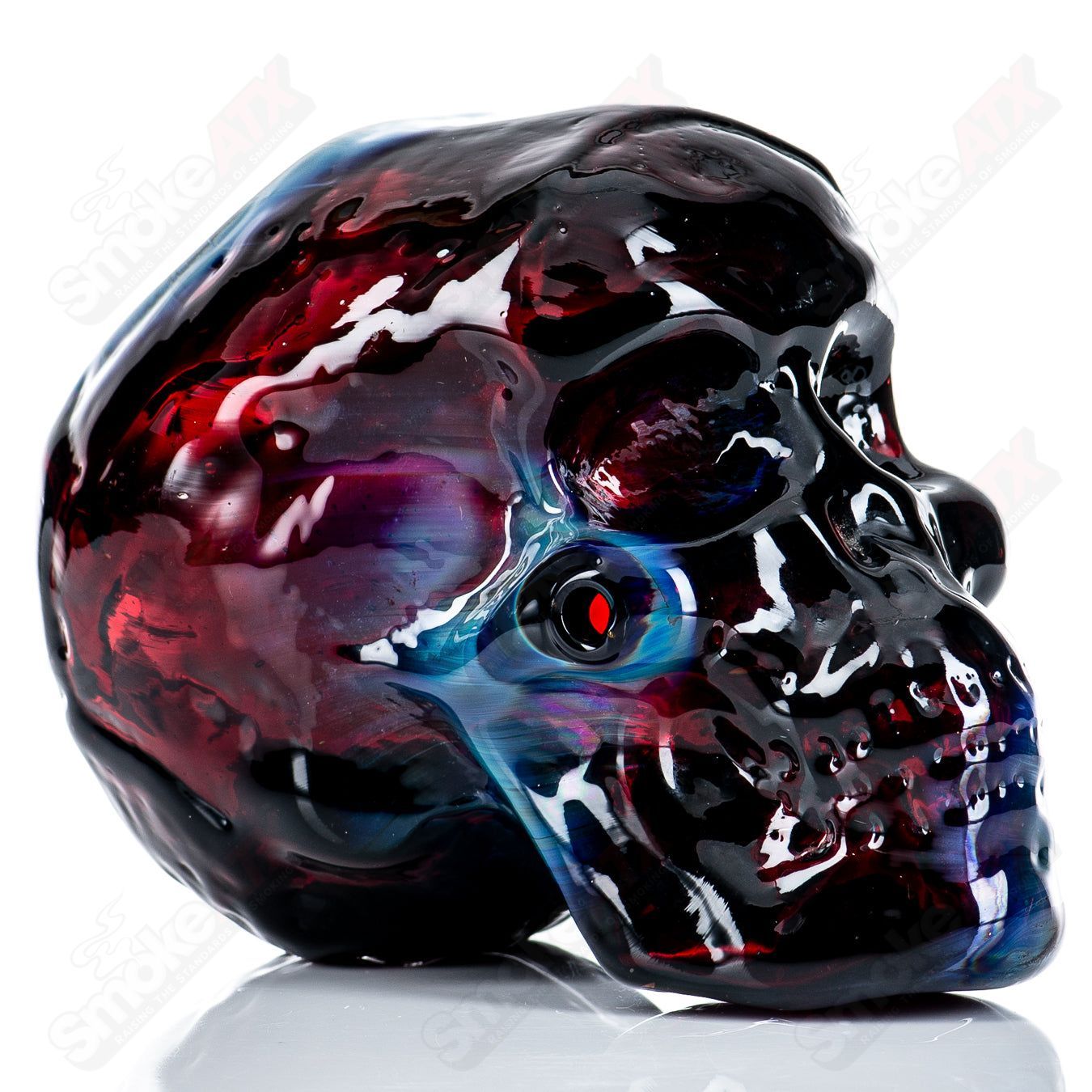 Fumed skull dry pipe by Team Snodgrass, handcrafted heady glass hand pipe with a smoky finish and detailed skull design.
