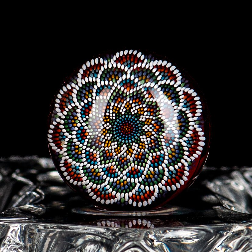 Colorful geometric slurper marble by JH Glassworks with intricate patterns on clear glass, showcases vibrant artistic design.