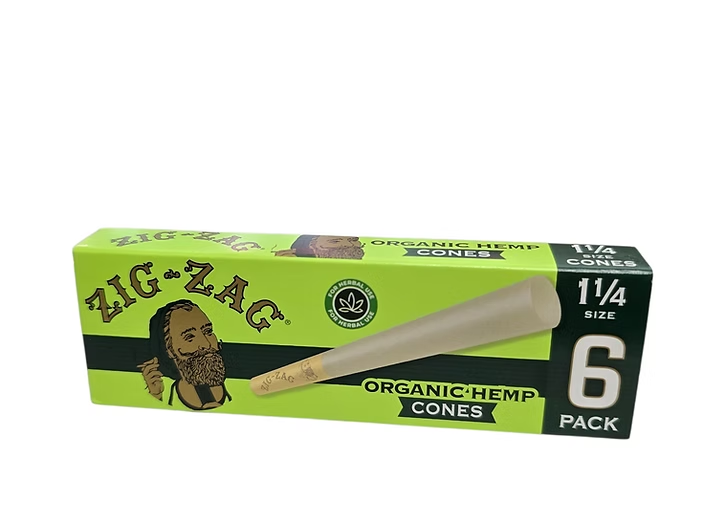 Six Zig Zag organic hemp cones, 1 1/4 size, ideal for rolling, shown in a natural setting with a focus on the product.