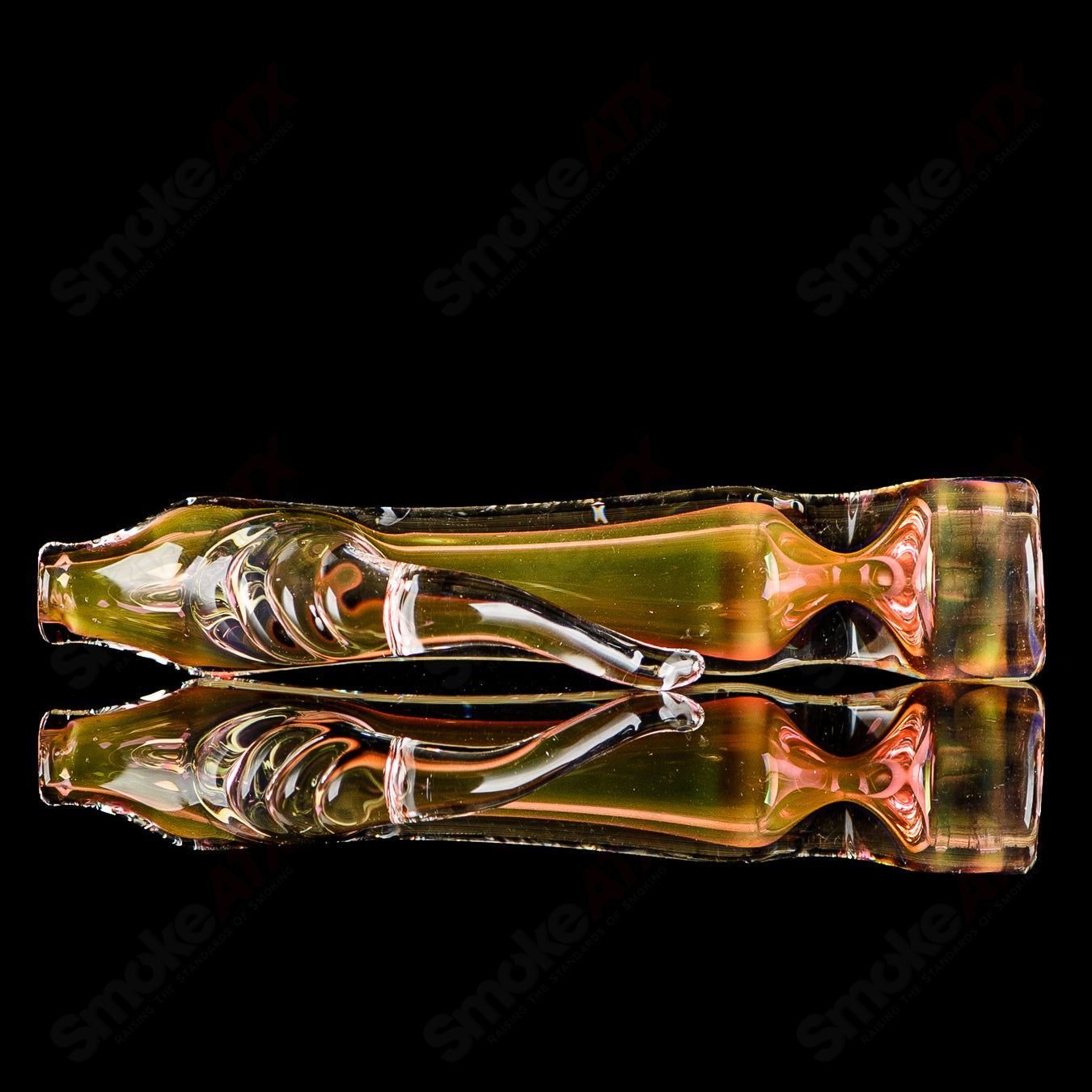 Gold fumed horn chillum with clear horn signed by JMK Glass, showcasing intricate glasswork and signature details.