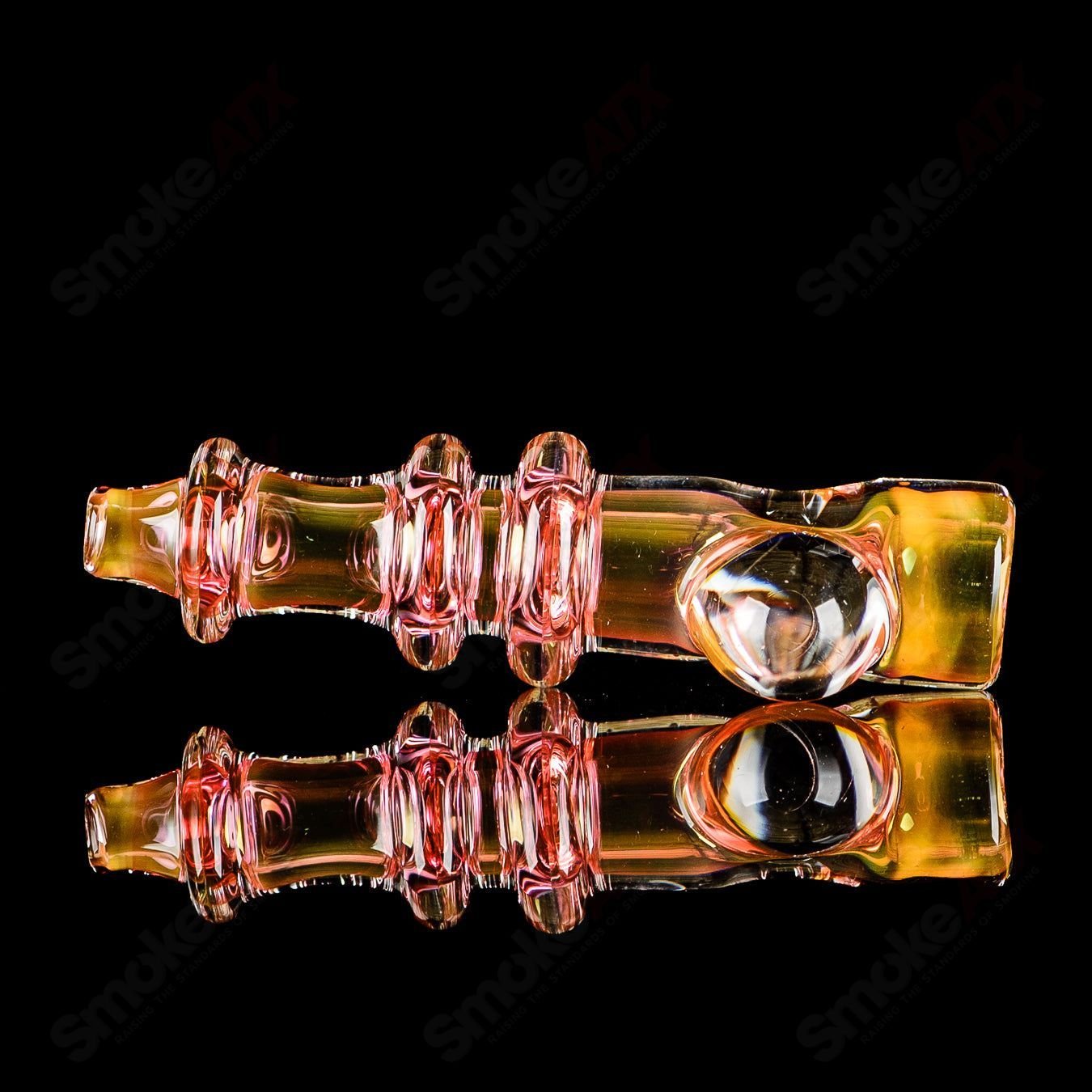 Gold fumed triple Maria chillum with clear dot design, signed by JMK Glass, showcasing intricate glasswork and vibrant colors.