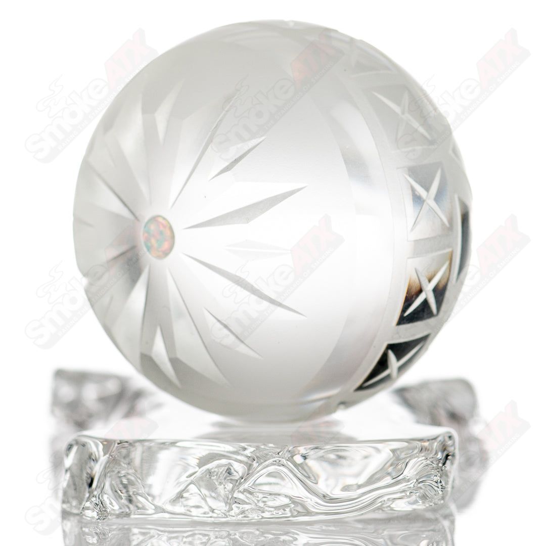 Large faceted snowflake marble by Fatal Facets, glass marble with intricate snowflake pattern and reflective faceted surface.