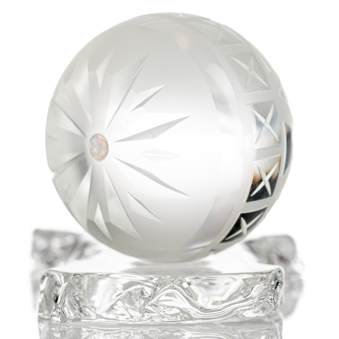 Large faceted snowflake marble by Fatal Facets, glass marble with intricate snowflake pattern and reflective faceted surface.