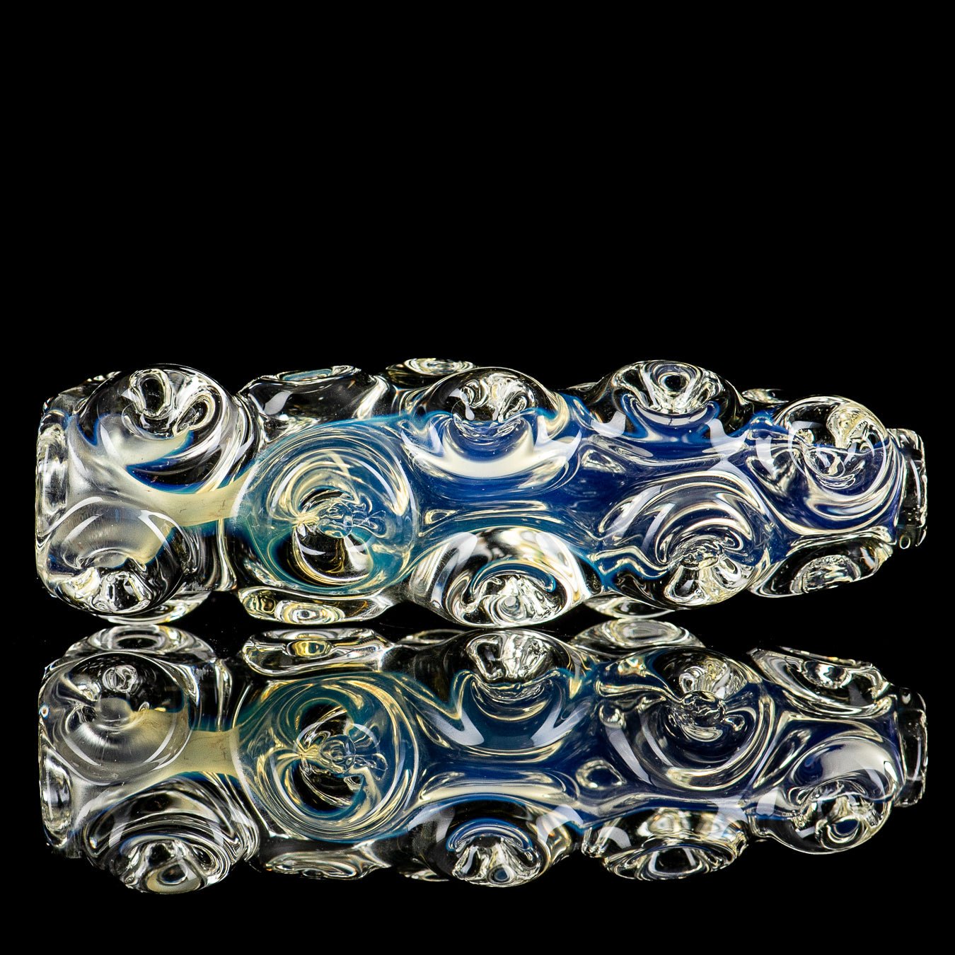 Clear glass Ice Chillum by JMK Glass, featuring a smooth, cylindrical shape with ice-catcher grooves for a cooling smoking experience.