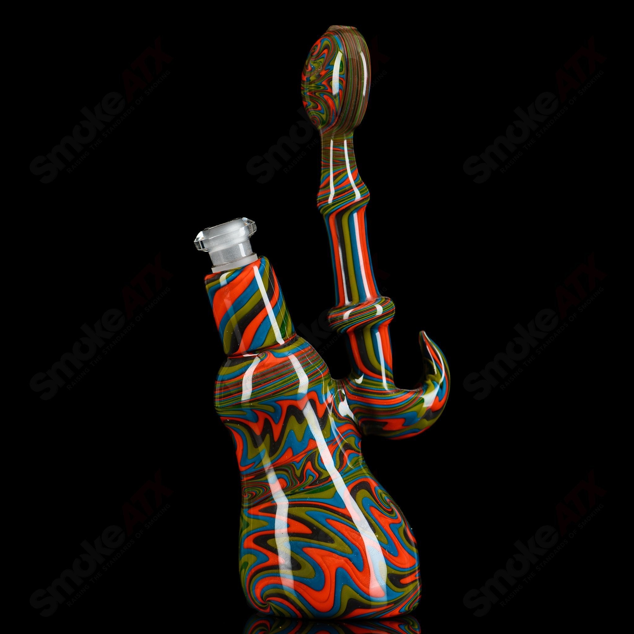 Glass concentrate rig by Trap Lord featuring a Wig Wag Pull Bub design with intricate glasswork and vibrant colors.