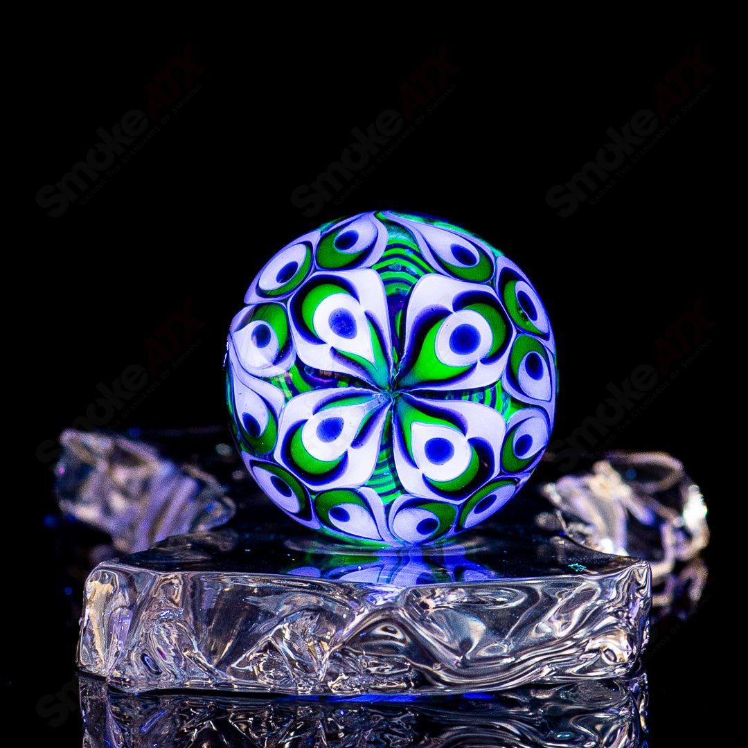 Black Magic UV Pinwheel Top Indo Glass marble, colorful optical illusion design in a clear glass sphere.