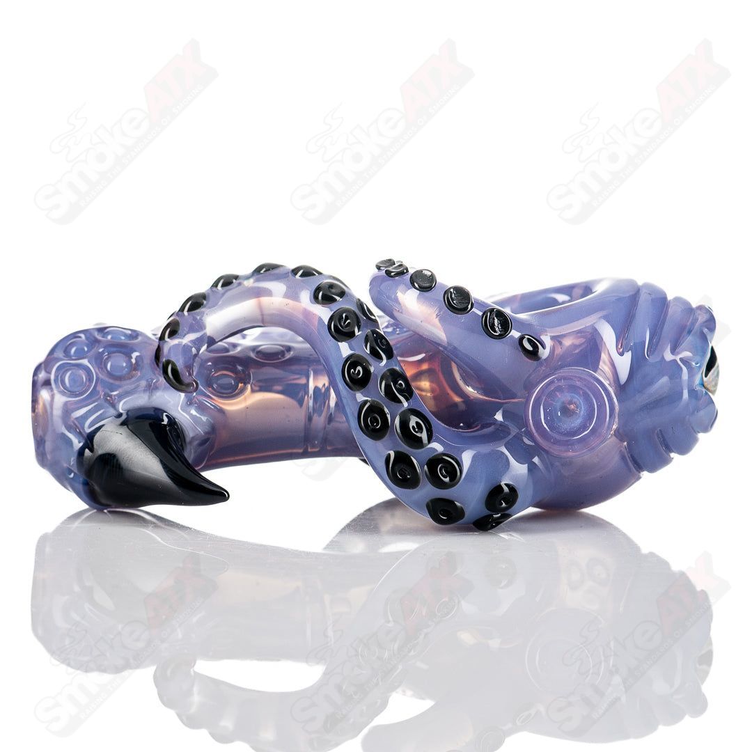 Handmade Seamonster spoon pipe by Mako Glass, clear heady glass with intricate sea creature design, suitable for dry herbs.