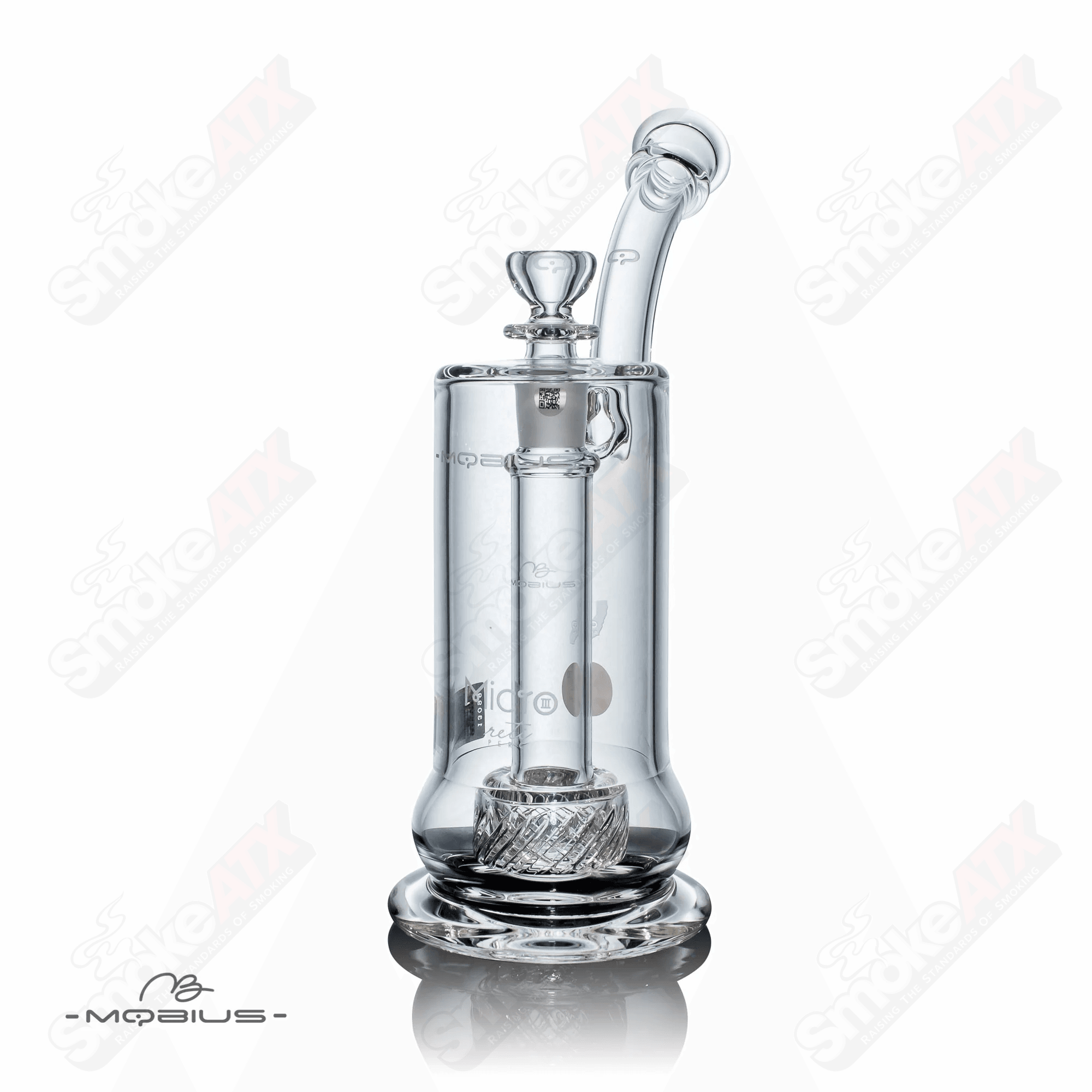 Glass bubbler called Micro Reti V3 Mobius with intricate design and clear glass body, showcasing detailed craftsmanship.