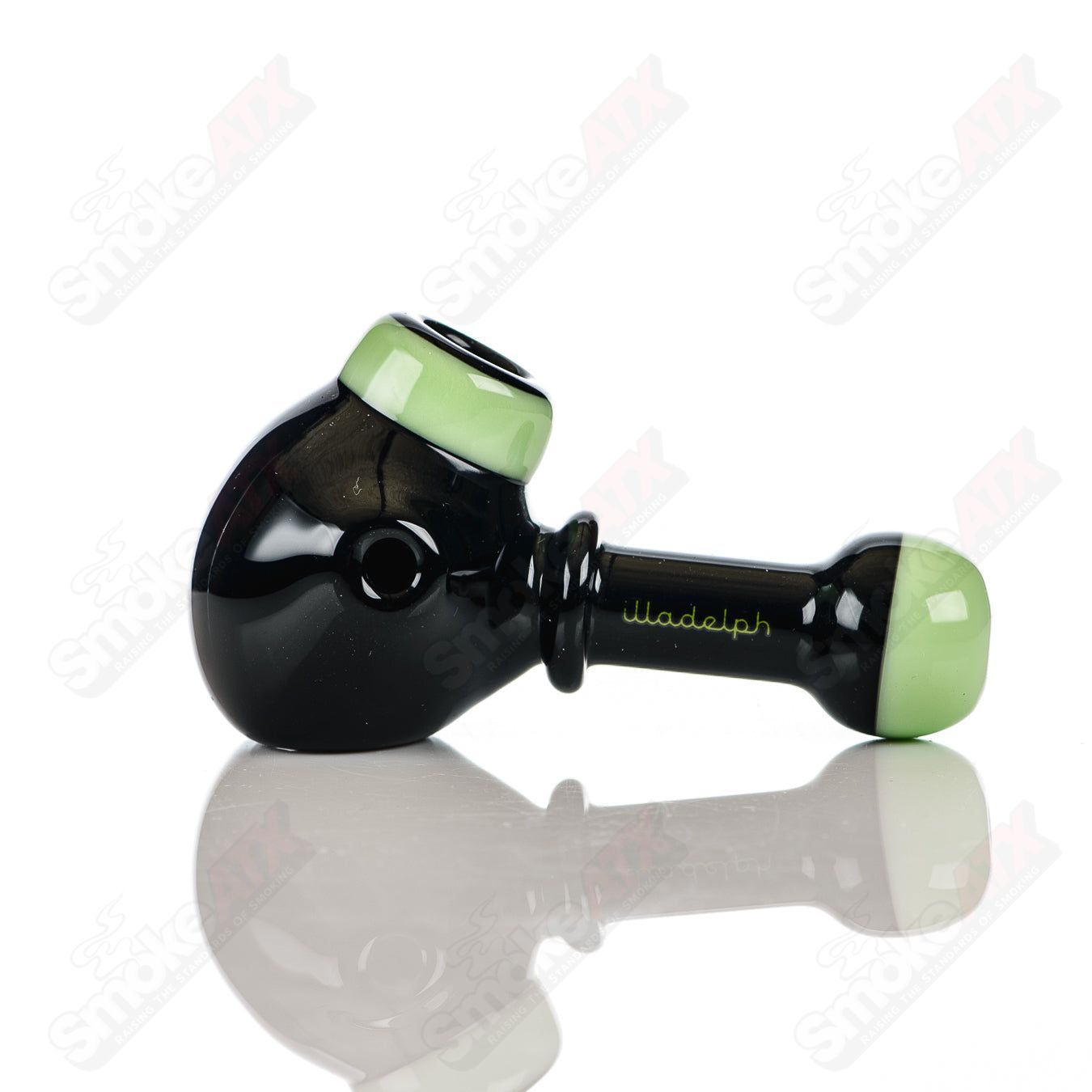 Illadelph black and milky green glass multi-hole spoon pipe with multiple holes for smooth smoking experience.