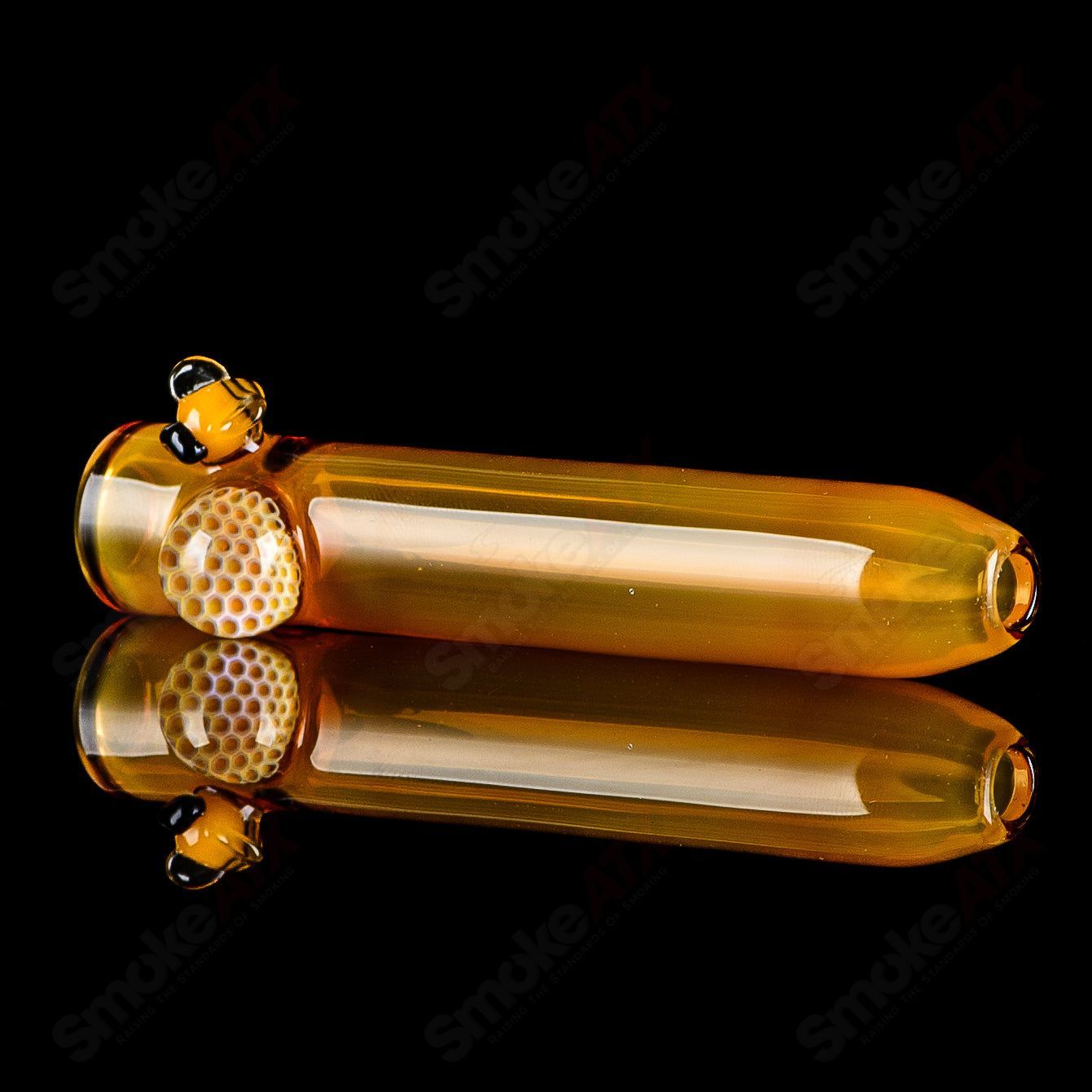 Joe P Glass honeycomb and bee chillum, a colorful heady glass one-hitter pipe with honeycomb and bee design.