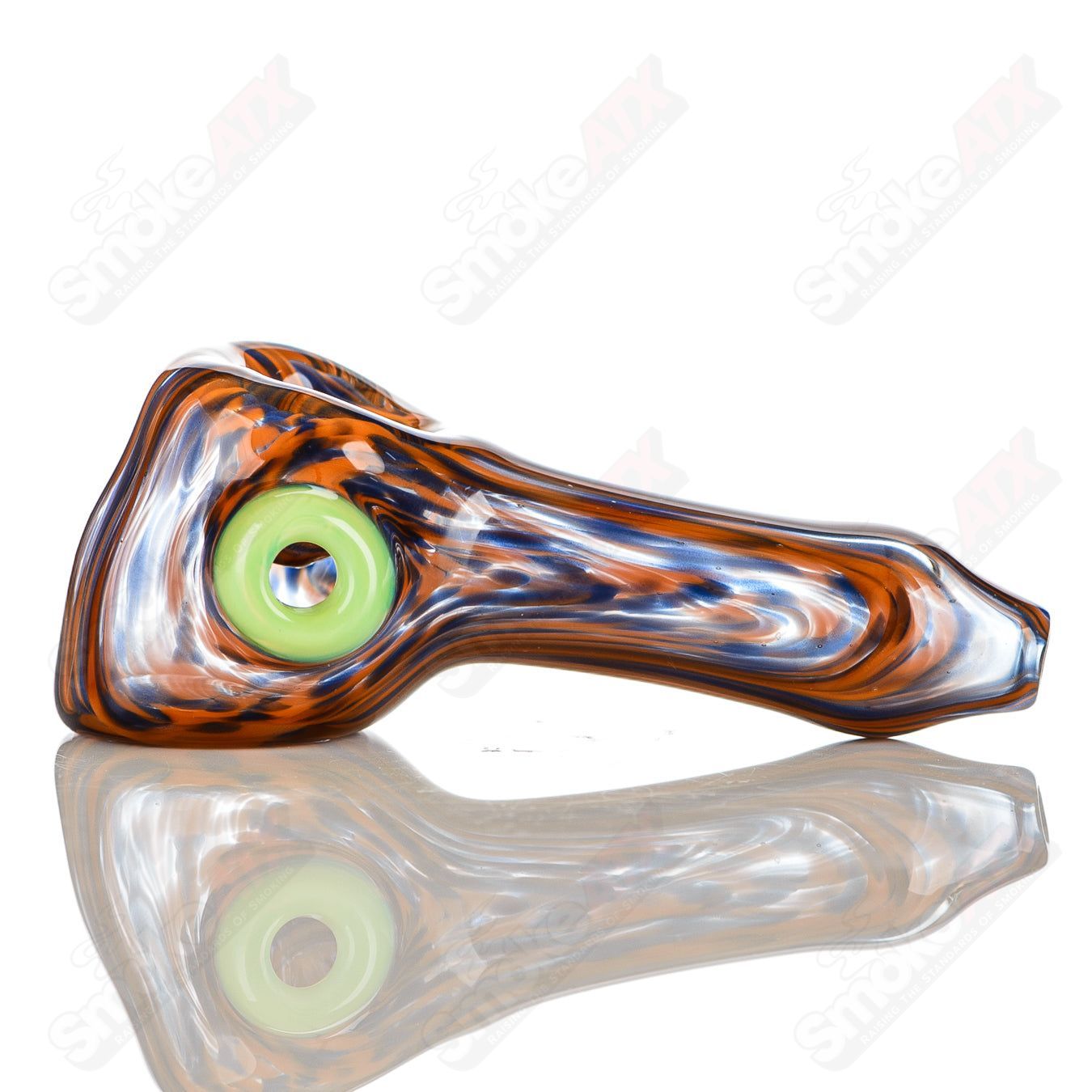 Handmade JMK Glass orange and purple worked spoon pipe with slyme accent and carved signature, designed for smoking enjoyment.