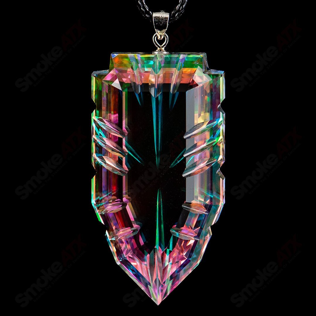 Faceted glass pendant by Fatal Facets, featuring a colorful, geometrically cut heady glass design hanging on a metal chain.