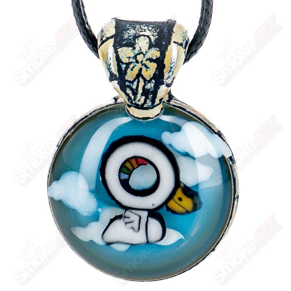 Heady glass pendant by Calmbo x Trevy Metal featuring intricate design and vibrant colors on a clear glass pendant.