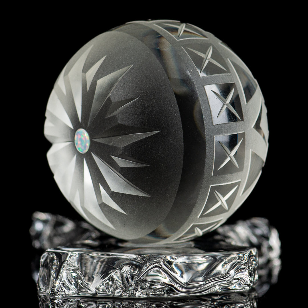 Large faceted snowflake marble from Fatal Facets, glass marble with intricate snowflake pattern and multiple facets.