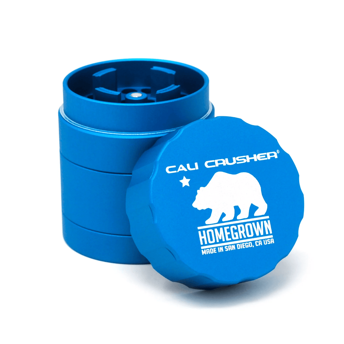 Pocket Cali Crusher 4-piece metal grinder in aquamarine with Homegrown branding, featuring sharp teeth and a magnetic lid.