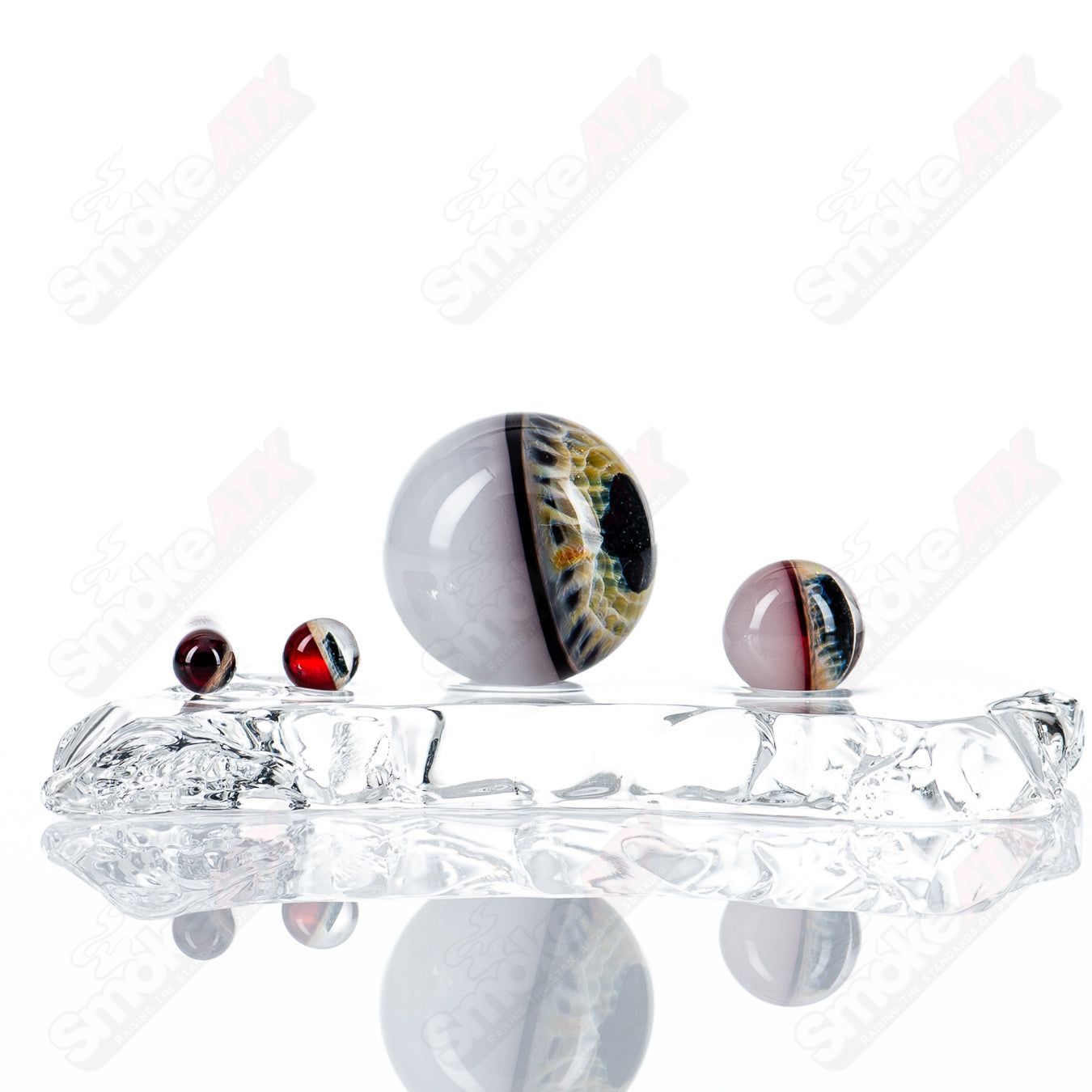 Pomegranate eye slurper set by Indo Glass featuring intricately designed glass accessories with pomegranate motifs.