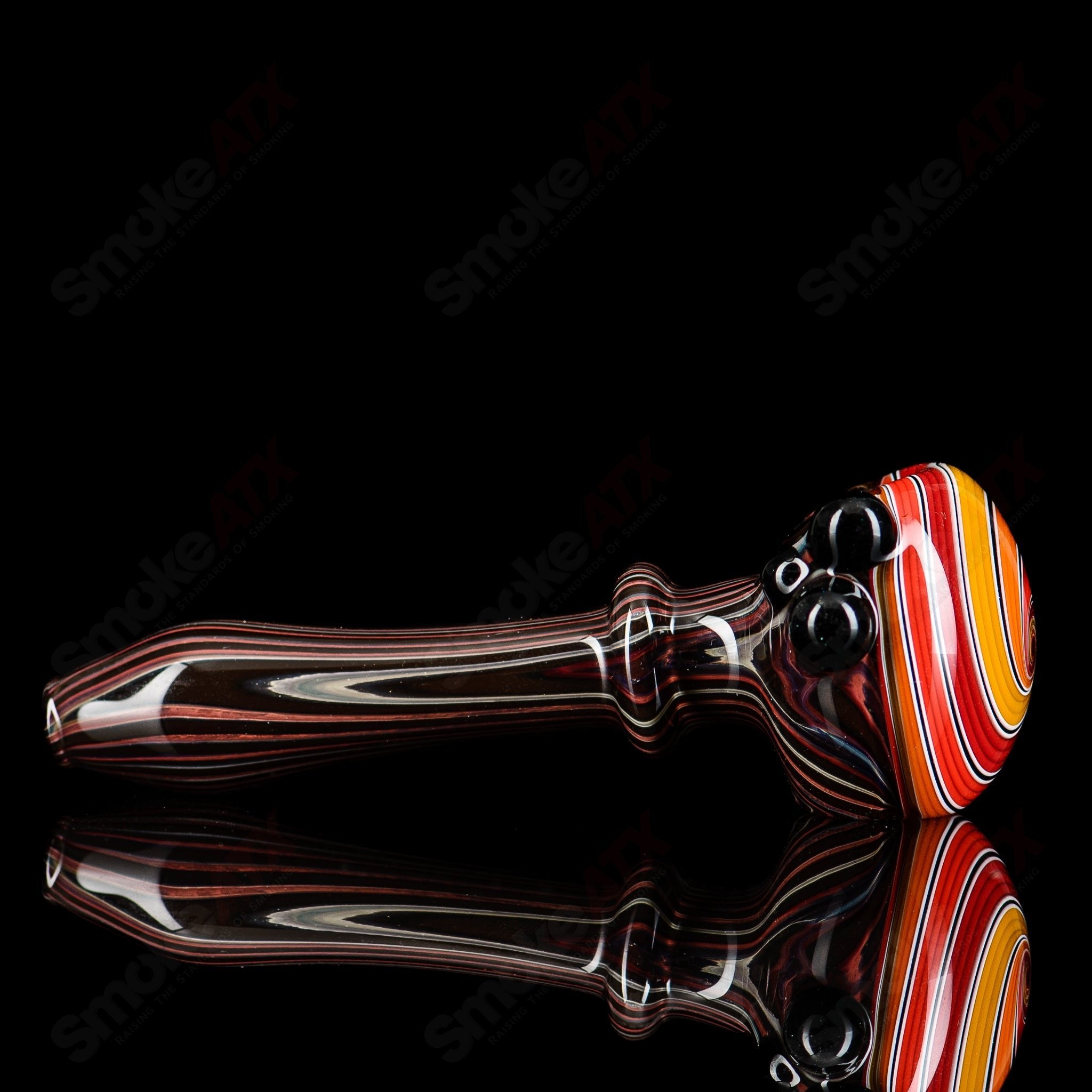 Wood grain spiral cap spoon for MTN Life Glass pipe, featuring a glass pipe with a spiral cap design and wood grain finish.