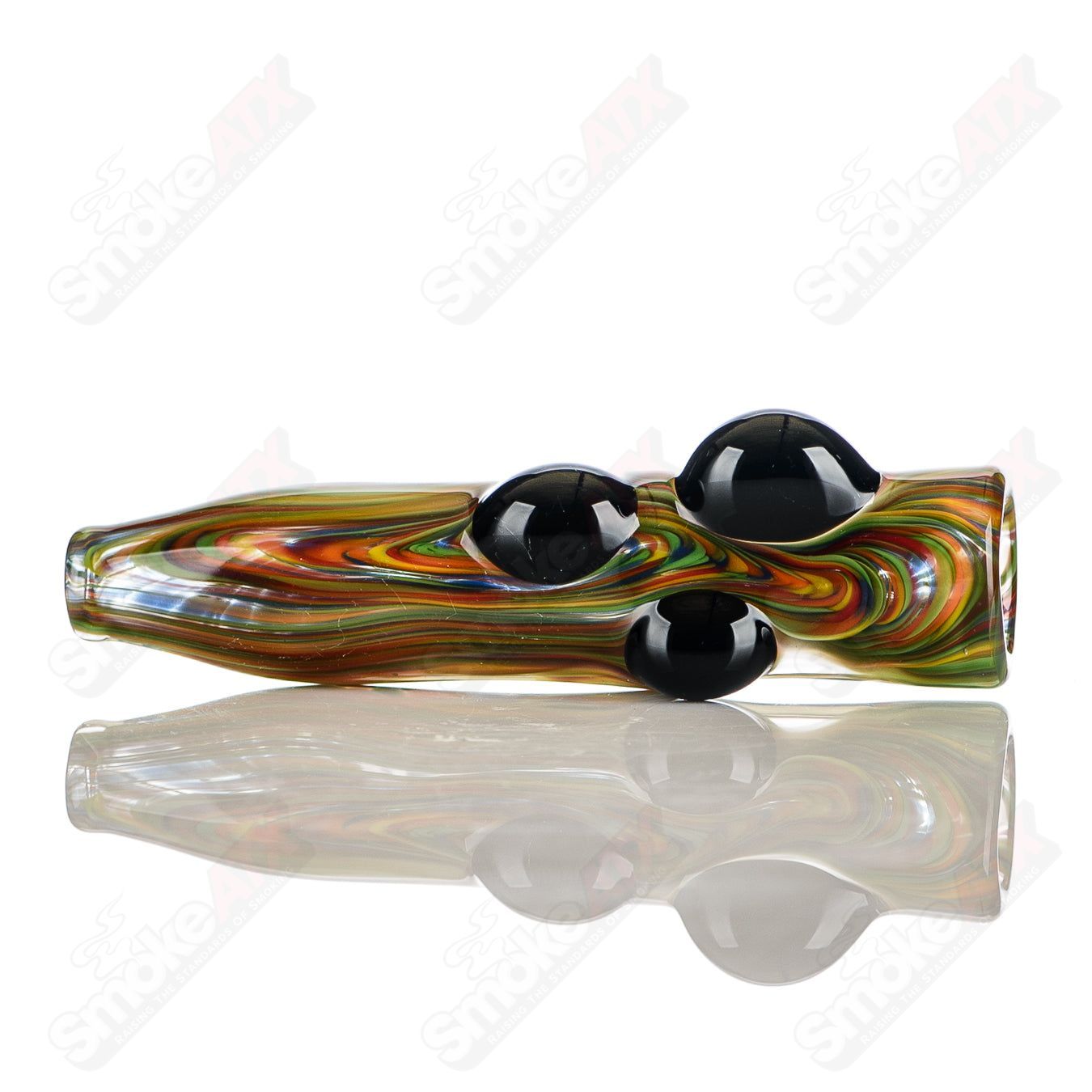 Rainbow-colored glass chillum with black dot accents and JMK Glass signature, featuring intricate worked design.