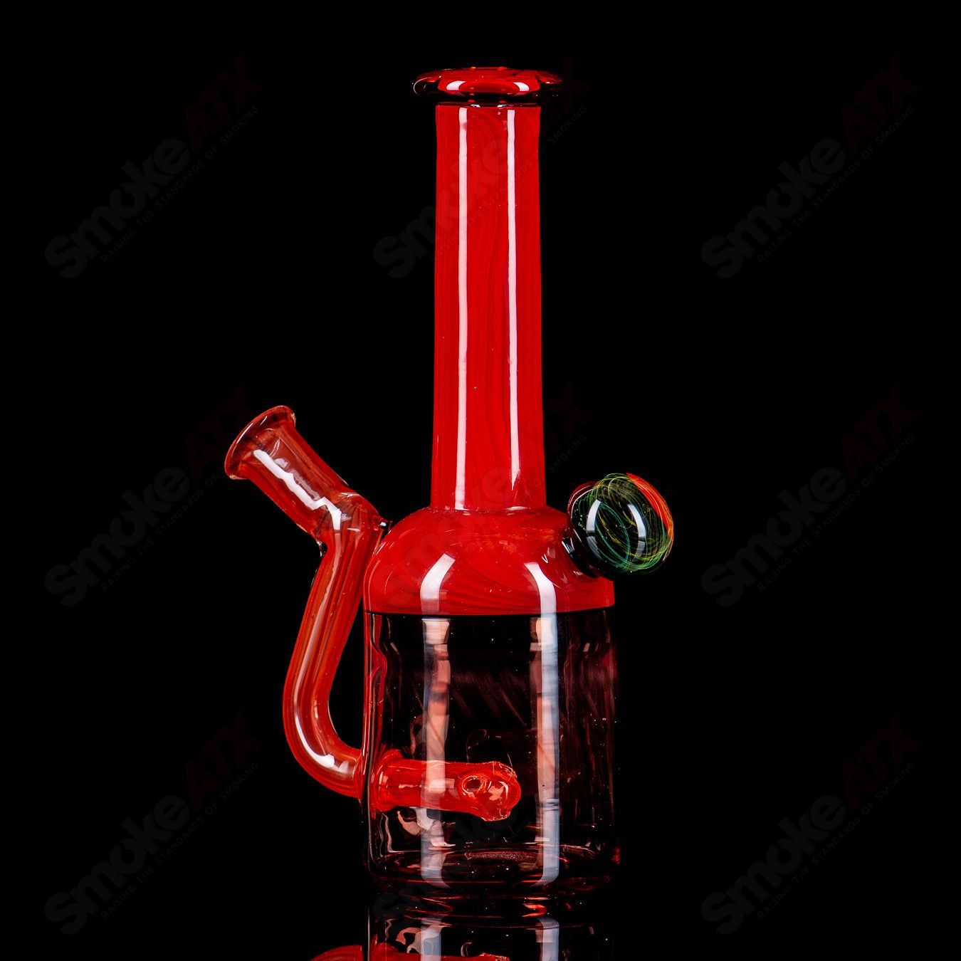 Red bell-shaped concentrate rig by Kate B Glass with fume marble design, featuring vibrant red glass and intricate marble details.