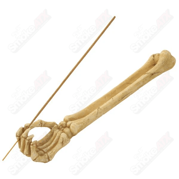 Skeleton arm incense boat from Wildberry, decorative black ceramic holder with incense sticks, ideal for aromatic ambiance.