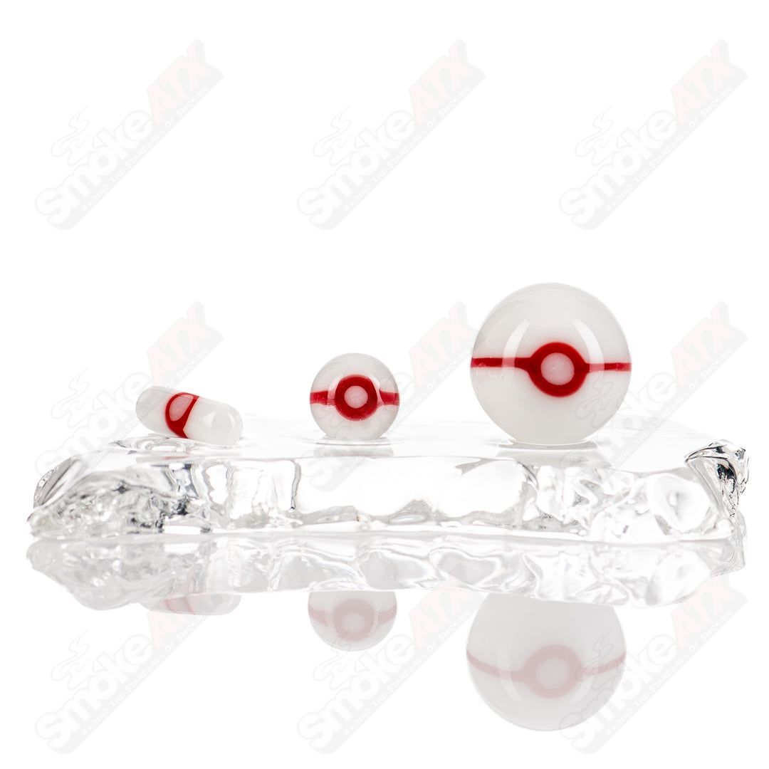 Three-piece Ganja Grimmlin Glass Pokeball Terp Slurper Set featuring colorful glass terp slurper tools and containers.