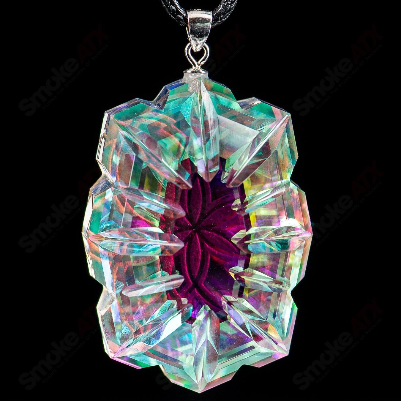 Fatal Facets SOL pendant made of heady glass with intricate fatal facet design, hanging from a cord on a neutral background.