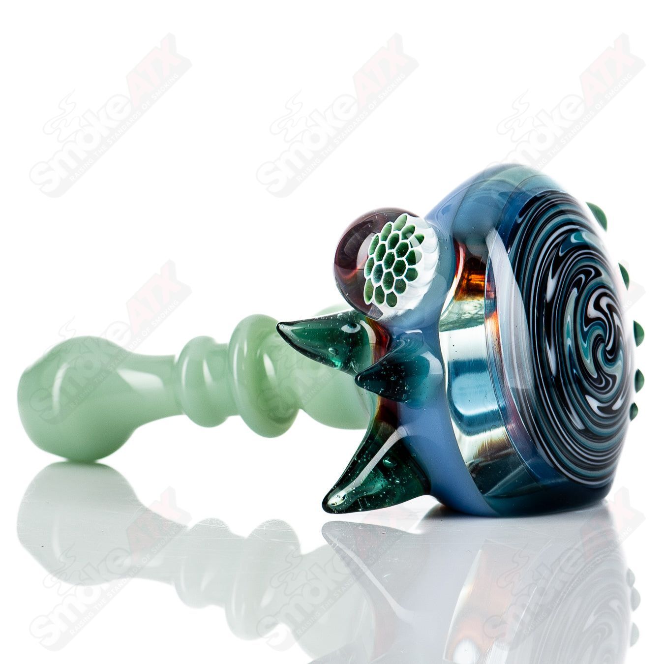 JMass Heady Glass spiked spoon hand pipe with honeycomb design, featuring textured spikes and clear glass accents.