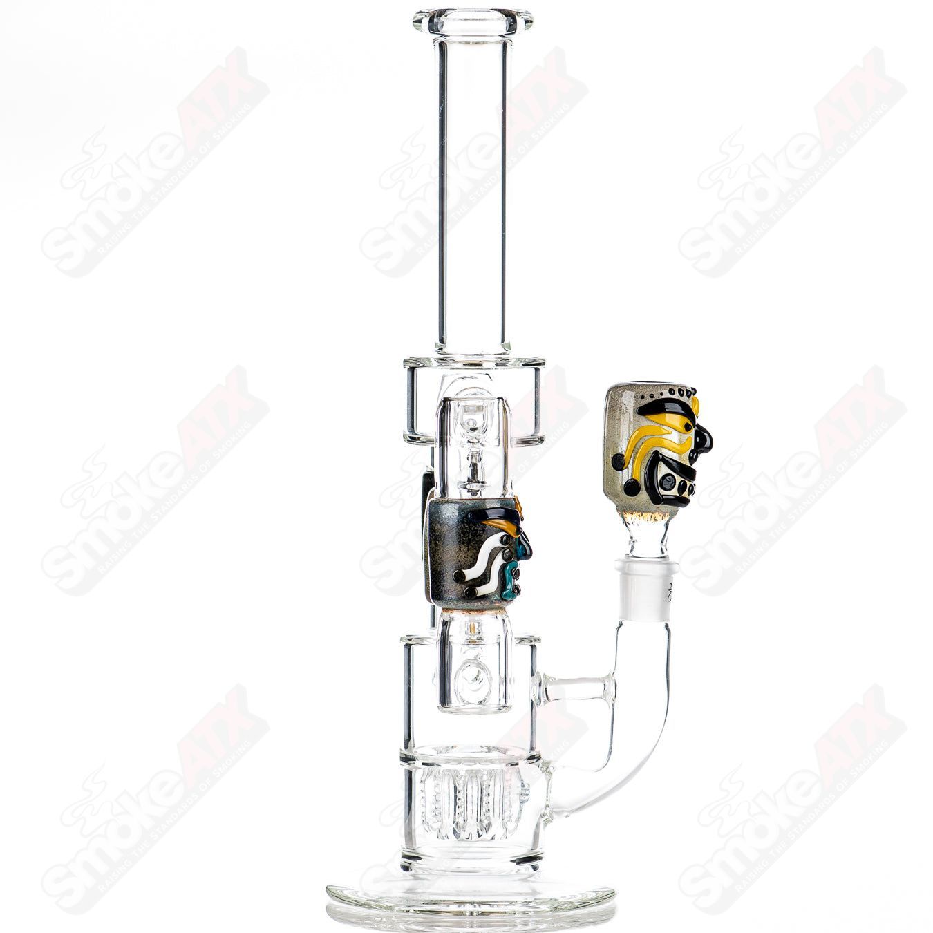 Spinning Tiki Head Scientific Tube by Carsten Carlile and Dirty Rico Glass, featuring detailed tiki head design and clear glass construction.