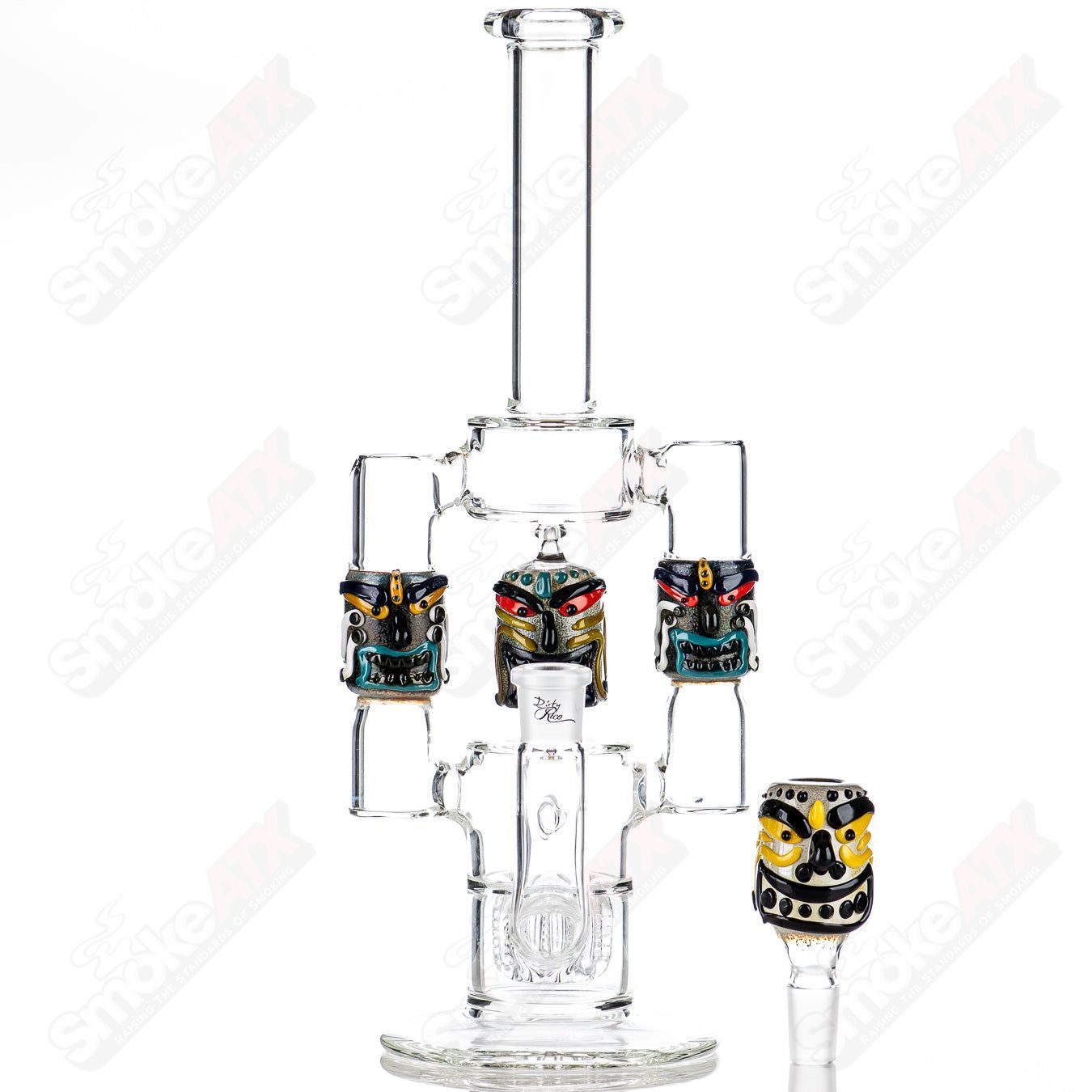 Spinning Tiki Head Scientific Tube by Carsten Carlile and Dirty Rico Glass, featuring a detailed tiki head design in heady glass art style.