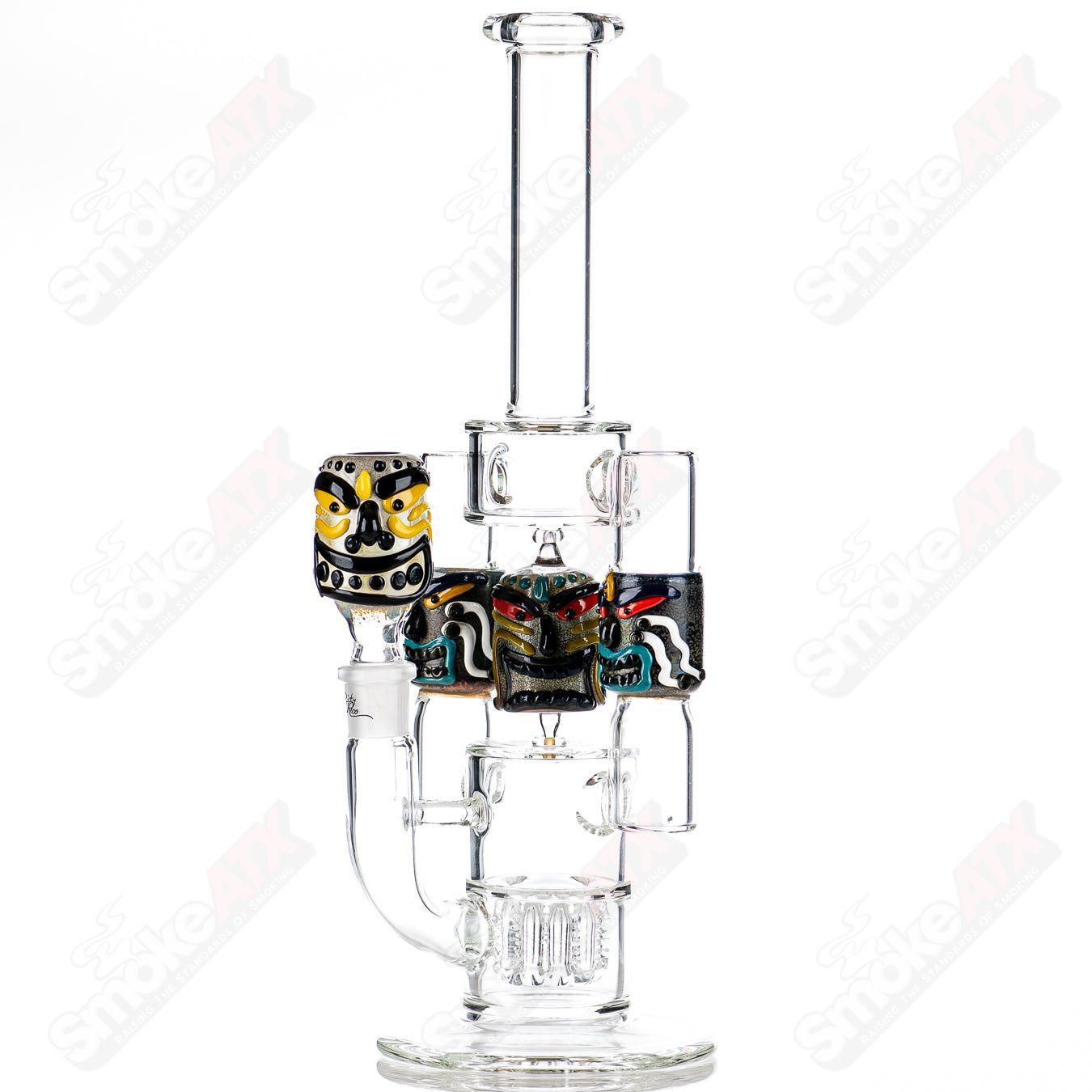 Spinning Tiki Head Scientific Tube by Carsten Carlile and Dirty Rico Glass, featuring vibrant tiki design and clear scientific glass construction.