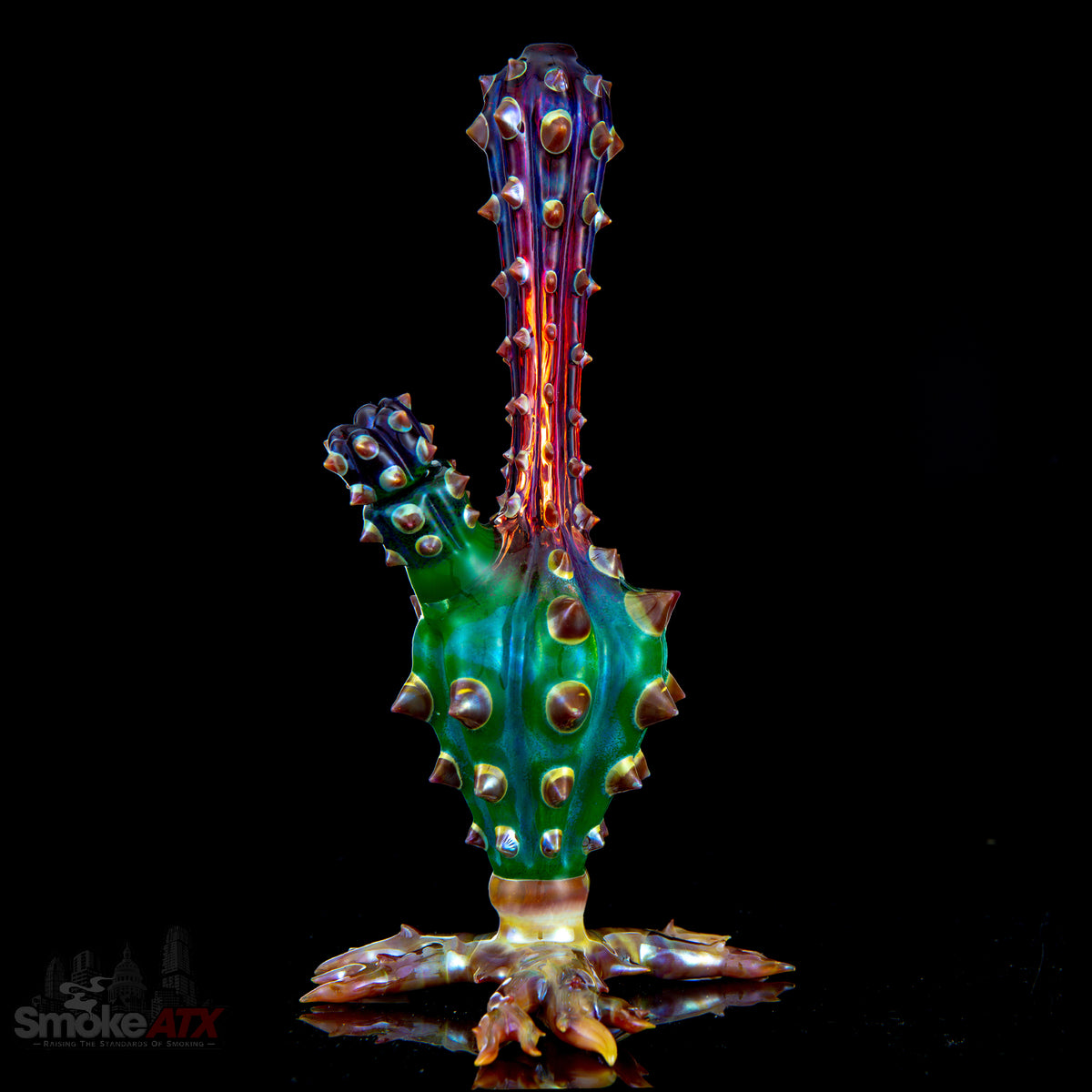 Colorful cactus-shaped glass vase by Unparalleled Glass, featuring a unique heady glass bubbler design in mixed vibrant colors.