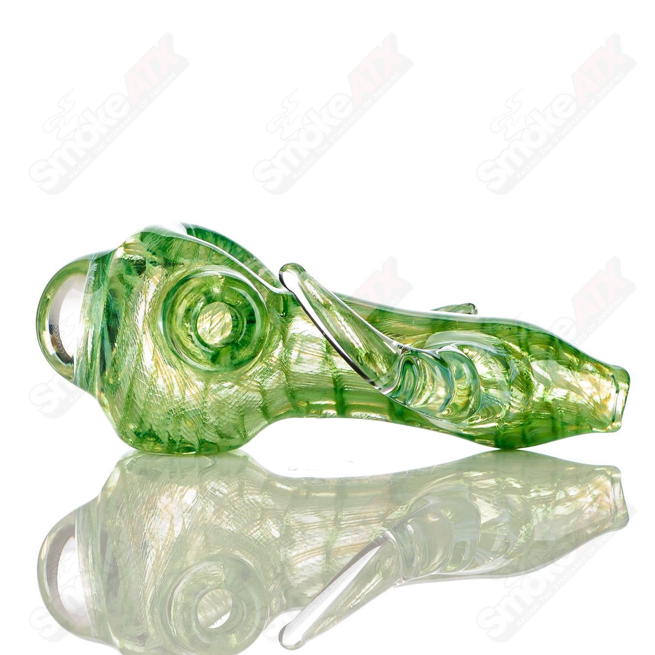 Transparent green I/O coil spoon hand pipe with clear horn accents, signed by JMK Glass, in a heady glass design.