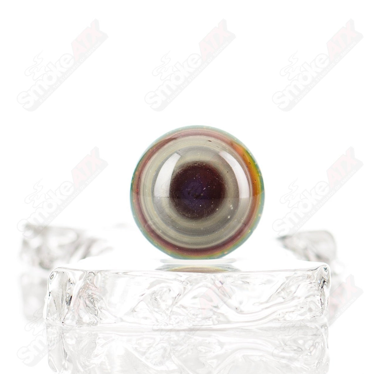Silver Creek Eye Marble by Indo Glass, clear glass marble with eye-like swirl pattern, showcasing intricate design and smooth surface.
