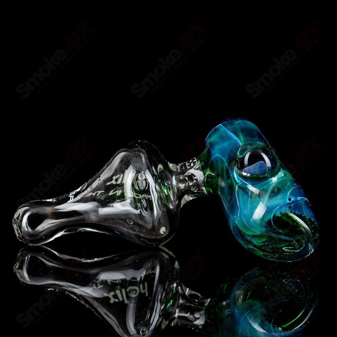 American Helix White Label Hammer glass pipe with blue-green box fan helix design, showcasing intricate glass craftsmanship.