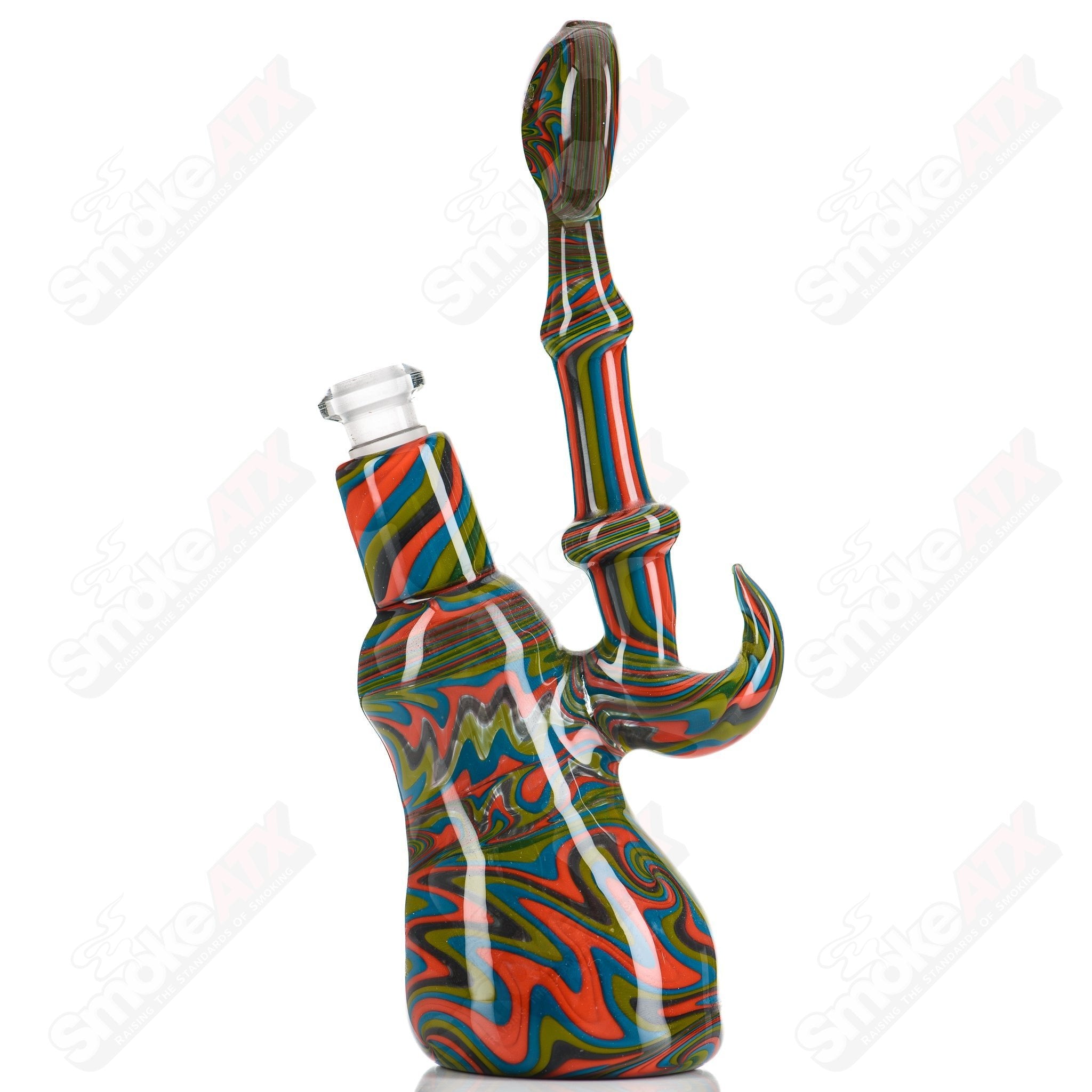 Glass concentrate rig featuring a Wig Wag Pull Bub design by Trap Lord with vibrant glass artwork.