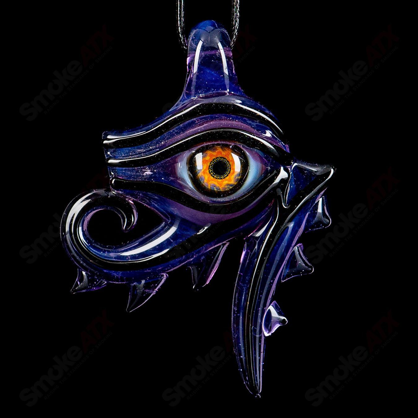 Eye of Horus pendant by Mako Glass, a detailed heady glass jewelry piece featuring the iconic Egyptian eye design.
