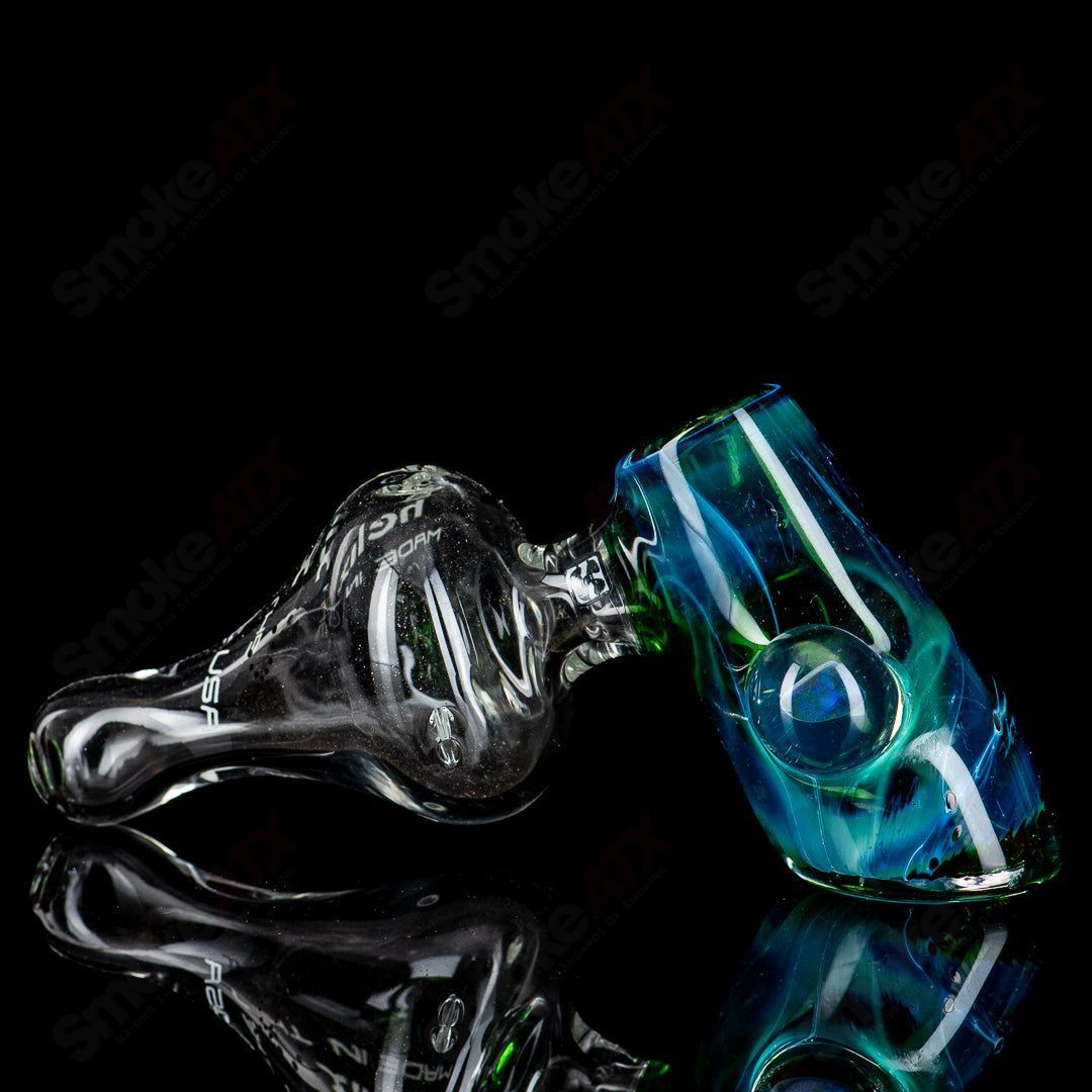 American Helix White Label Hammer glass pipe with blue-green box fan helix design, showcasing intricate glass craftsmanship.