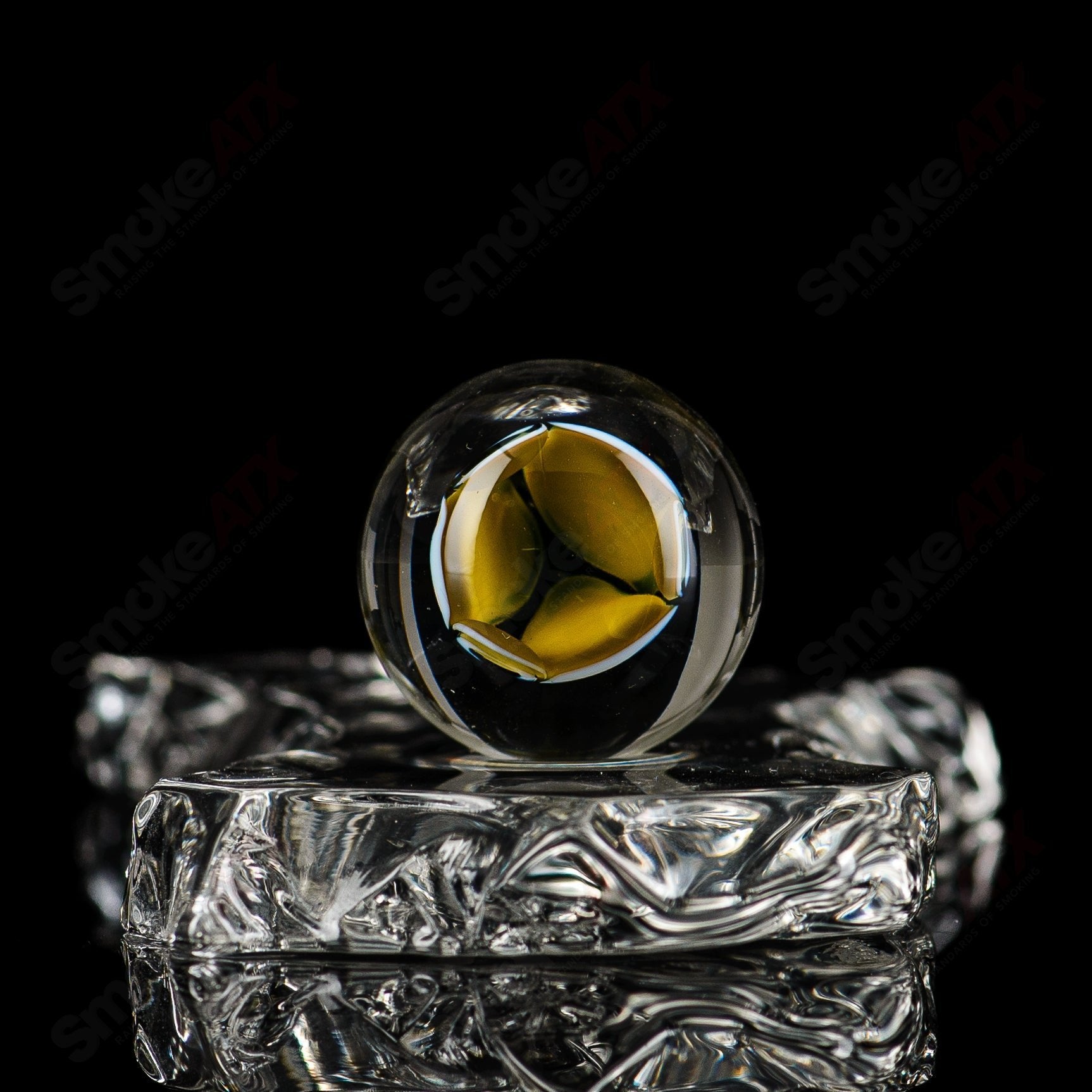 Glass marbles from Indo Glass, featuring a Dotstack Lattis Top marble design with a marble pattern in shades of white and gray.