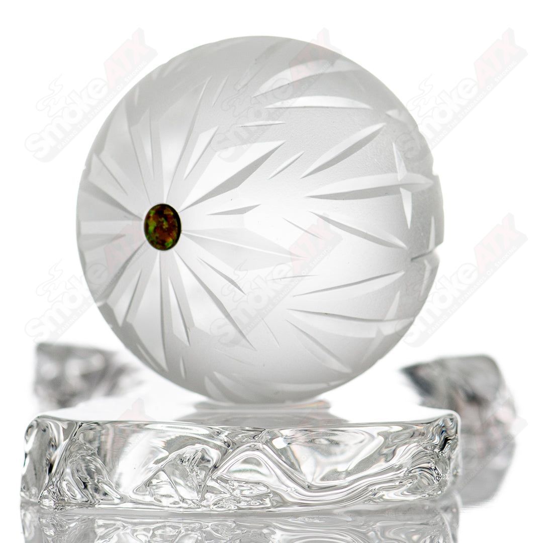 Faceted snowflake marble by Fatal Facets, glass marble with intricate snowflake pattern and shiny, reflective surface.