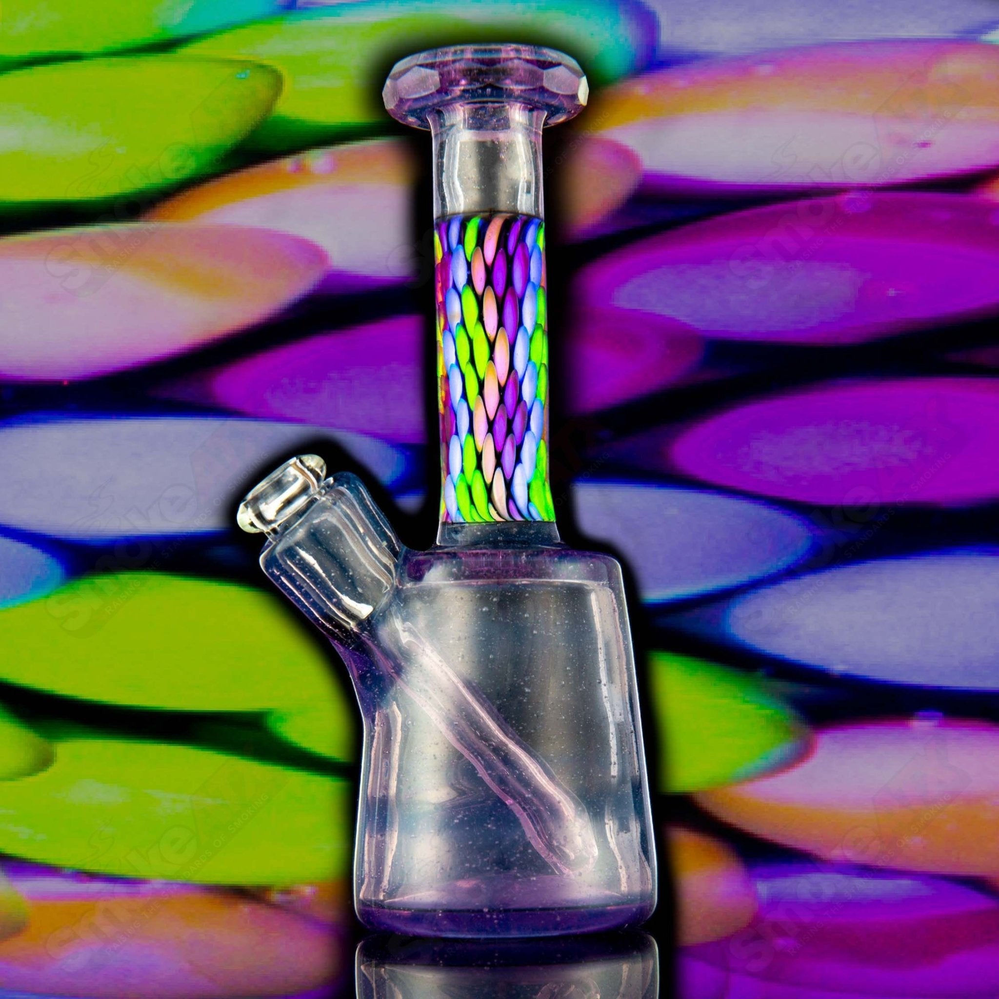 Faceted UV Mini Rig by BCM Glass, a colorful heady glass concentrate rig with intricate faceted design and UV-reactive glass.