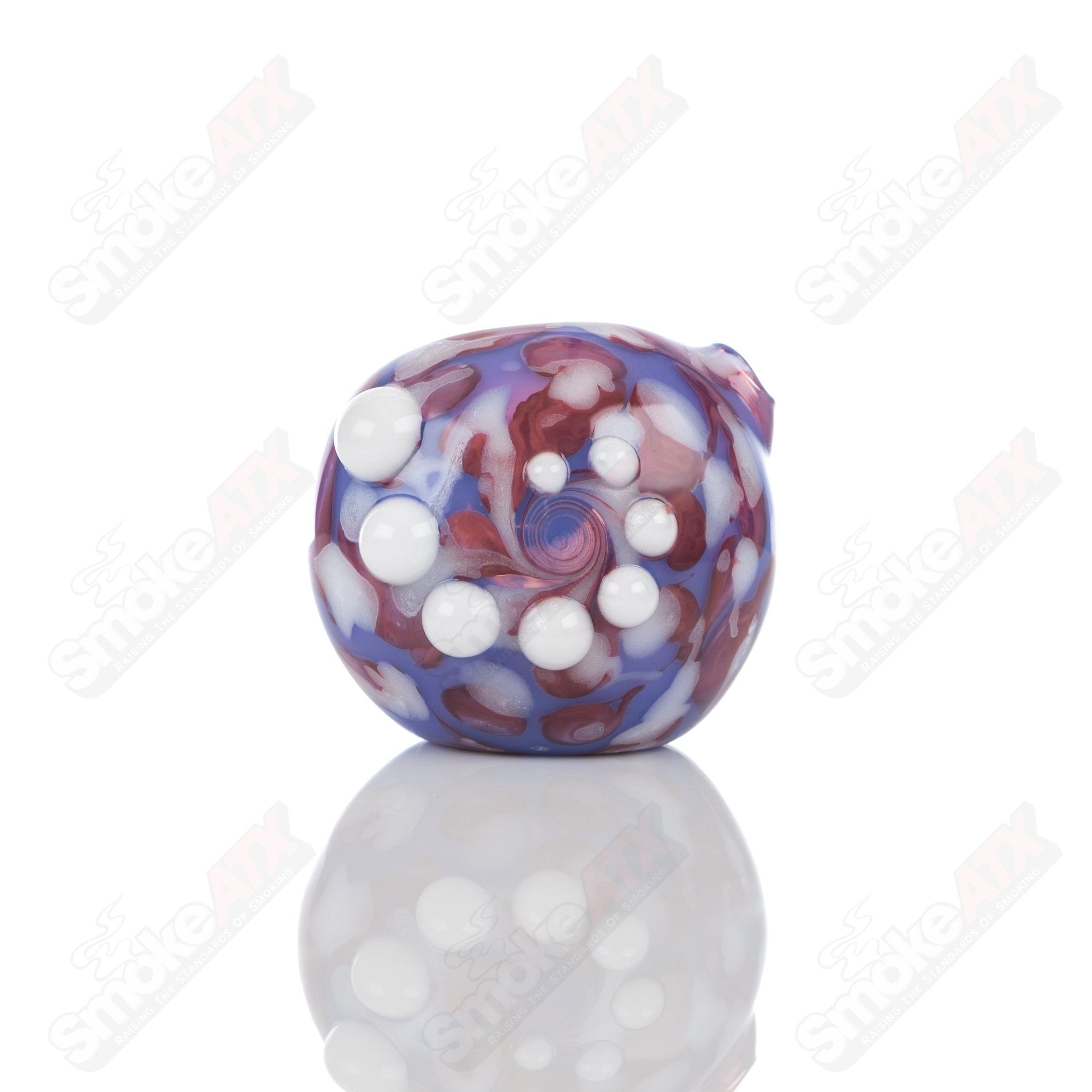 Purple splatter glass spoon pipe from Adventures In Glass Blowing, featuring a colorful, artistic design and smooth glass finish.