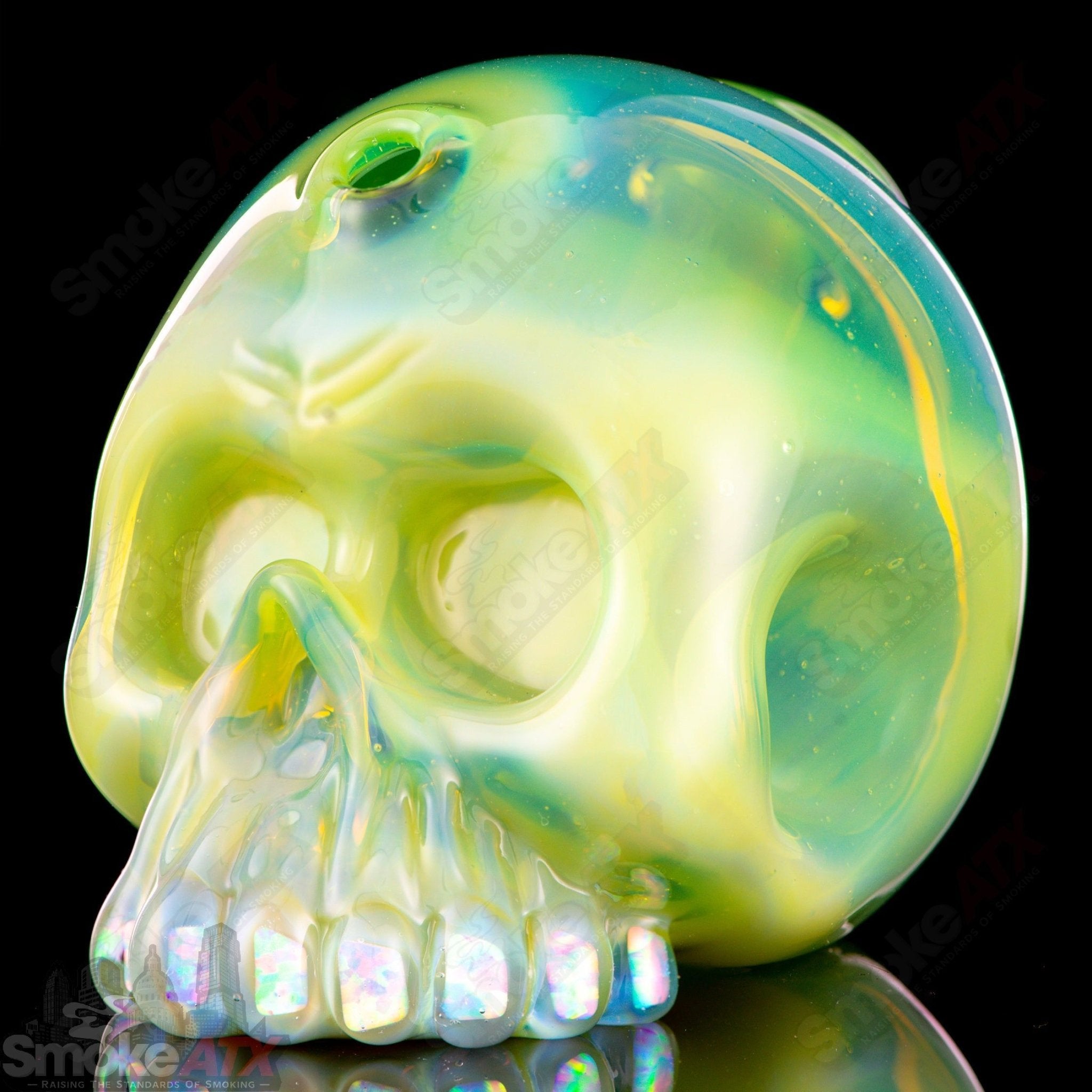 10mm Guava Roots Skull Shredder concentrate rig by Carsten Carlile, with colorful glass design and intricate skull details.