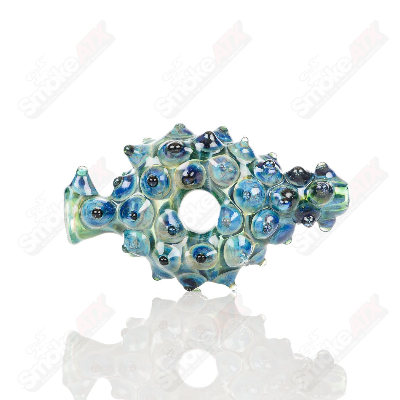 Large glass Donut Chillum by Baby Dabs, featuring a colorful donut design, used for smoking concentrates or herbs.