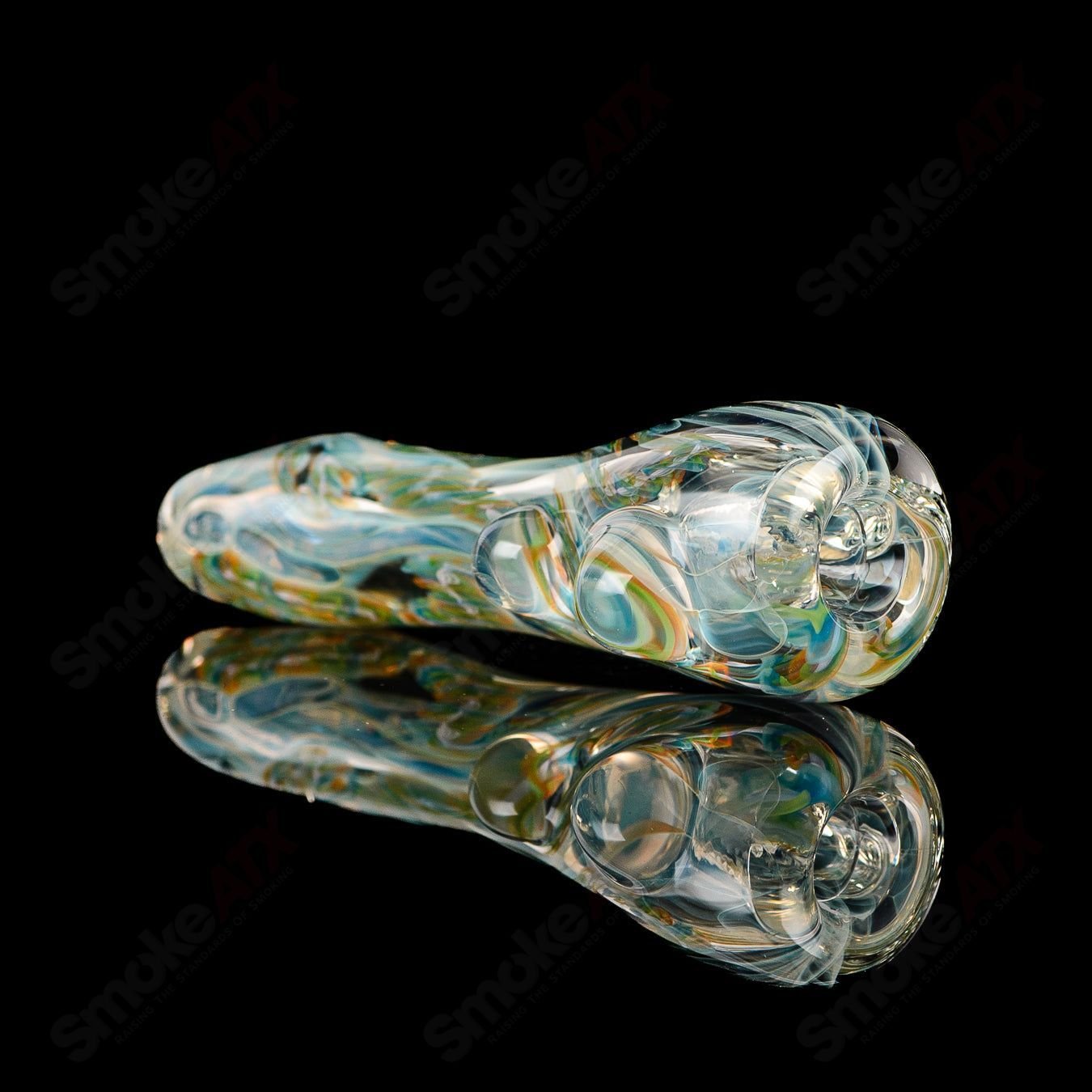 Close-up of the Texas Hot Glass Taster #26 Chillum, clear glass smoking pipe with a smooth, rounded bowl and straight neck.