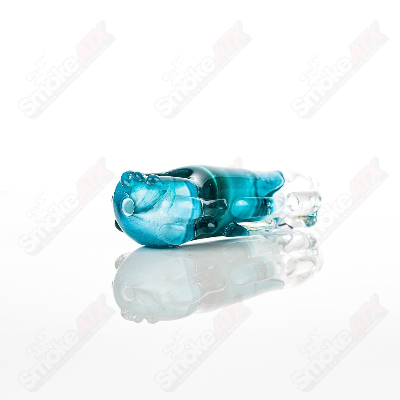 Glass pipe in the shape of a spoon, labeled #32 Spoon Glass by Nobody, featuring clear glass with a smooth bowl and stem.