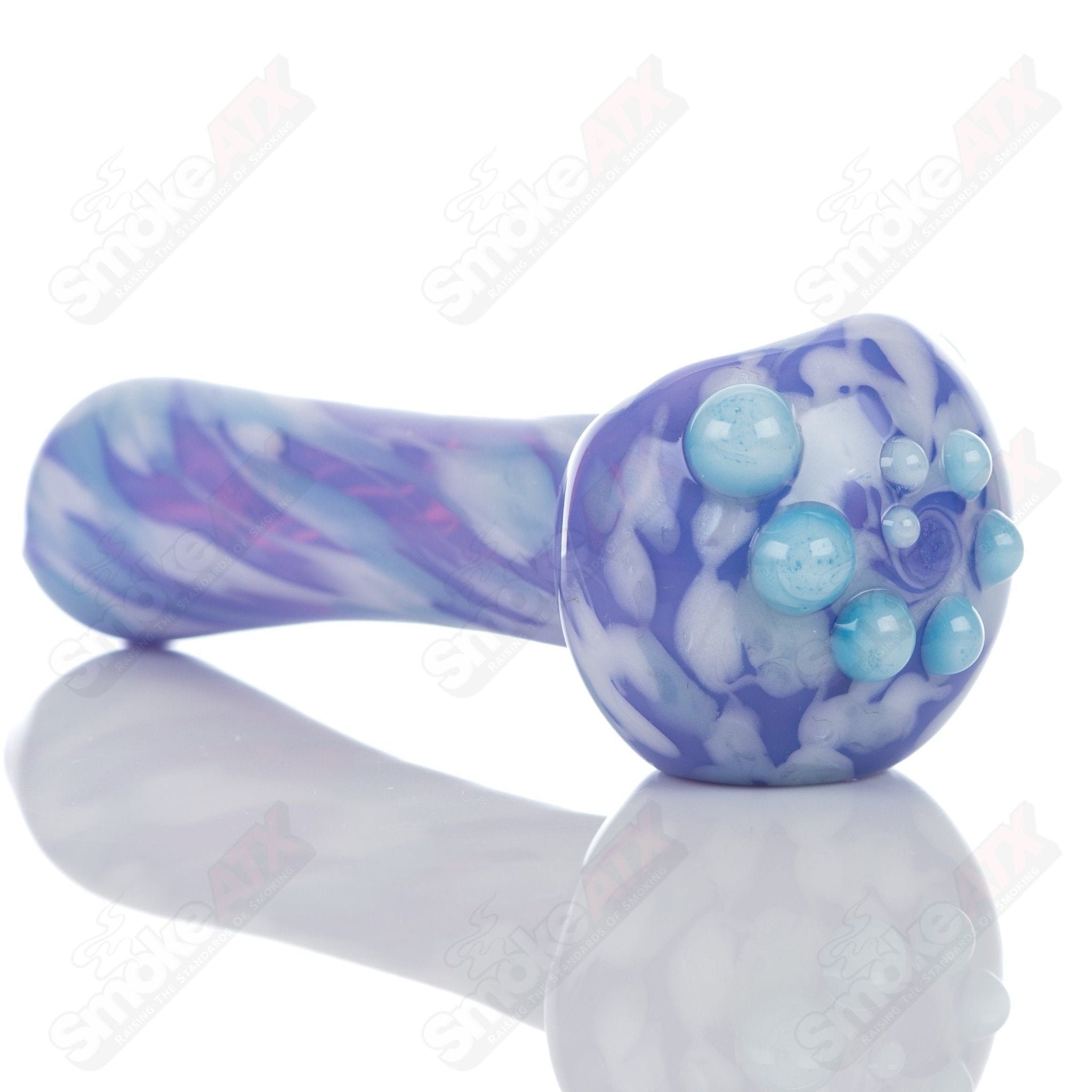 Purple splatter glass spoon pipe by Adventures In Glass Blowing, showcasing a colorful, hand-blown smoking pipe with unique design.