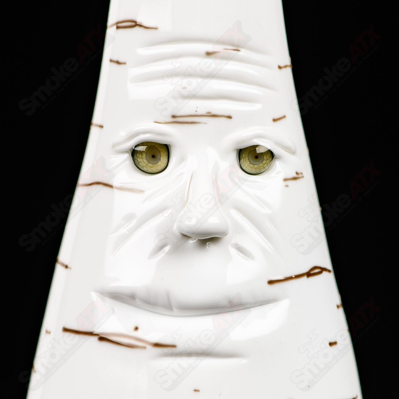 Foster Glass Birch Face Rig, a heady glass concentrate rig with intricate facial design and clear glass accents.